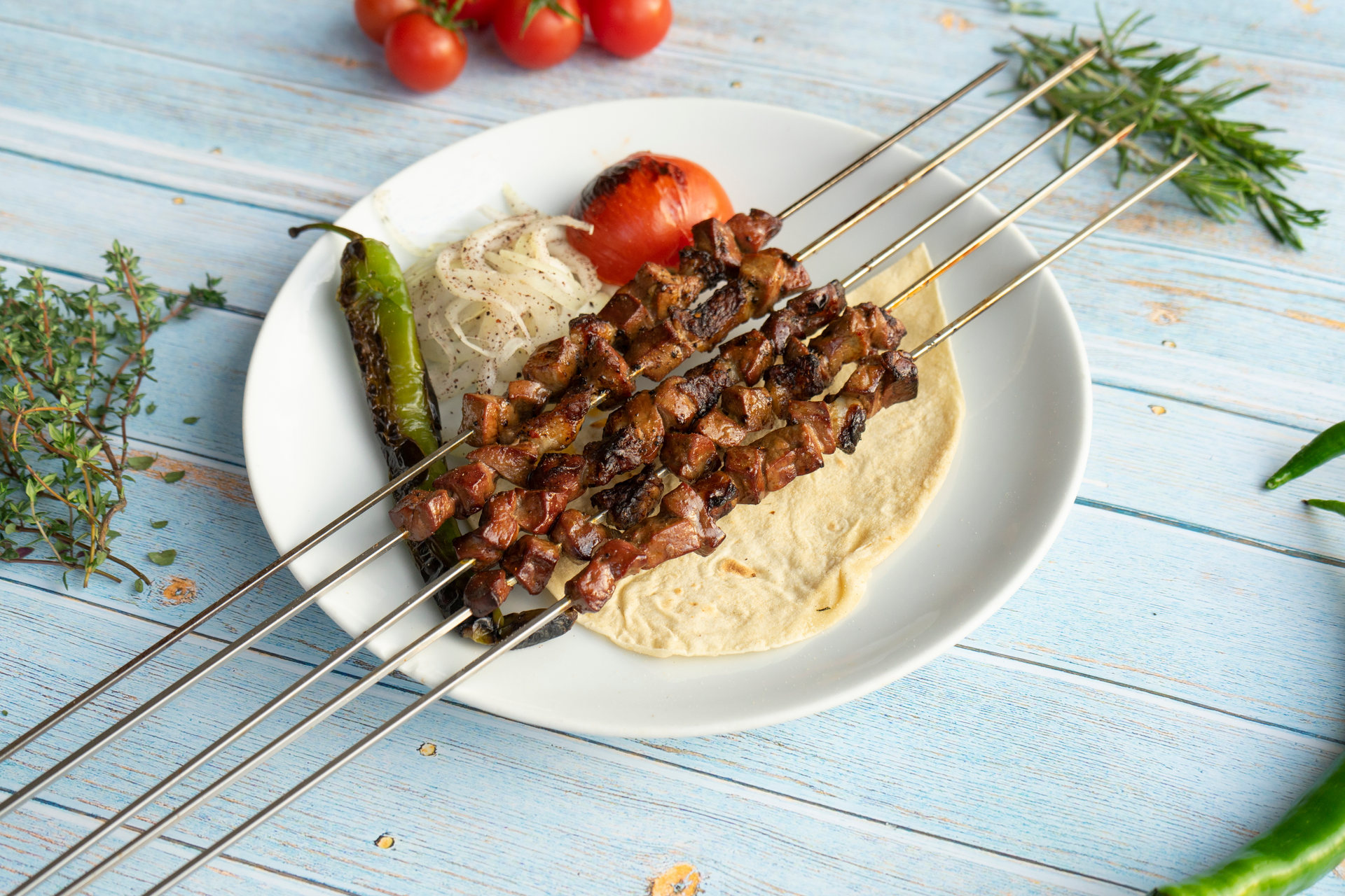 Overhead flat-lay of all ingredients for Fragrant Lebanese Kafta Kebabs with Pine Nut Sauce laid out on a kitchen surface.