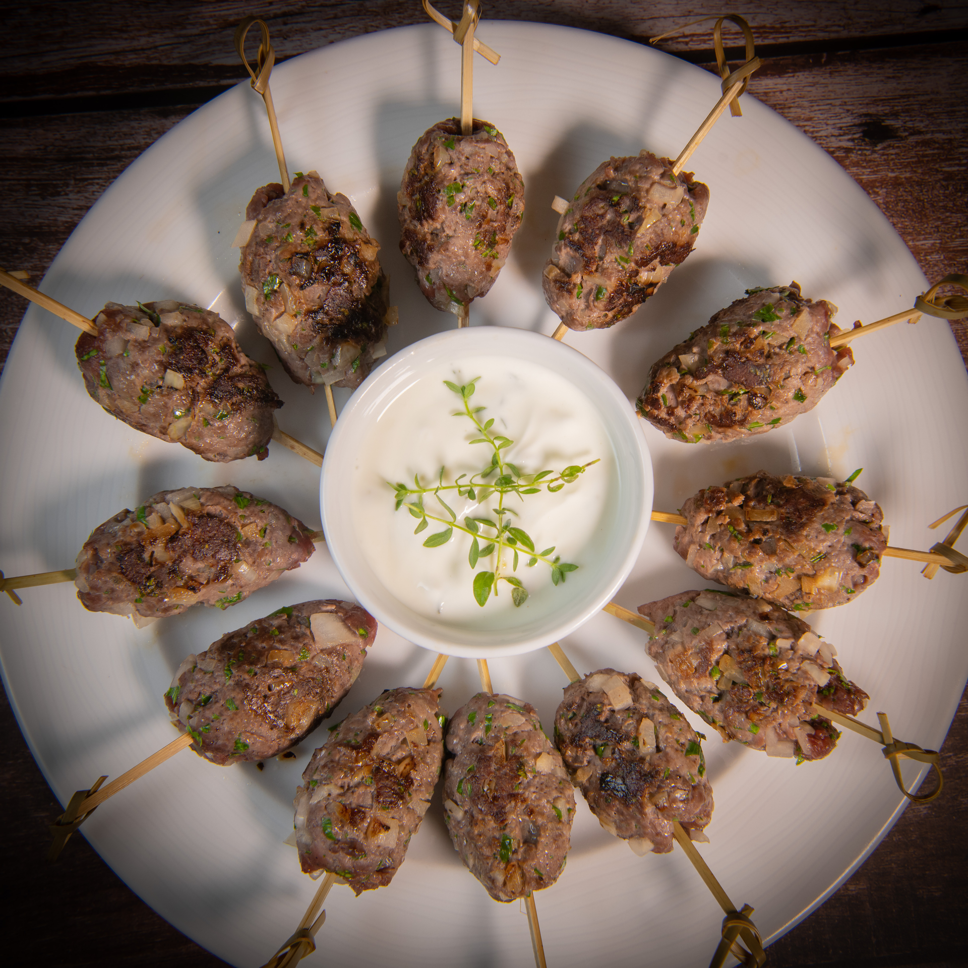 Fragrant Lebanese Kafta Kebabs with Pine Nut Sauce — Main Course served and photographed from above