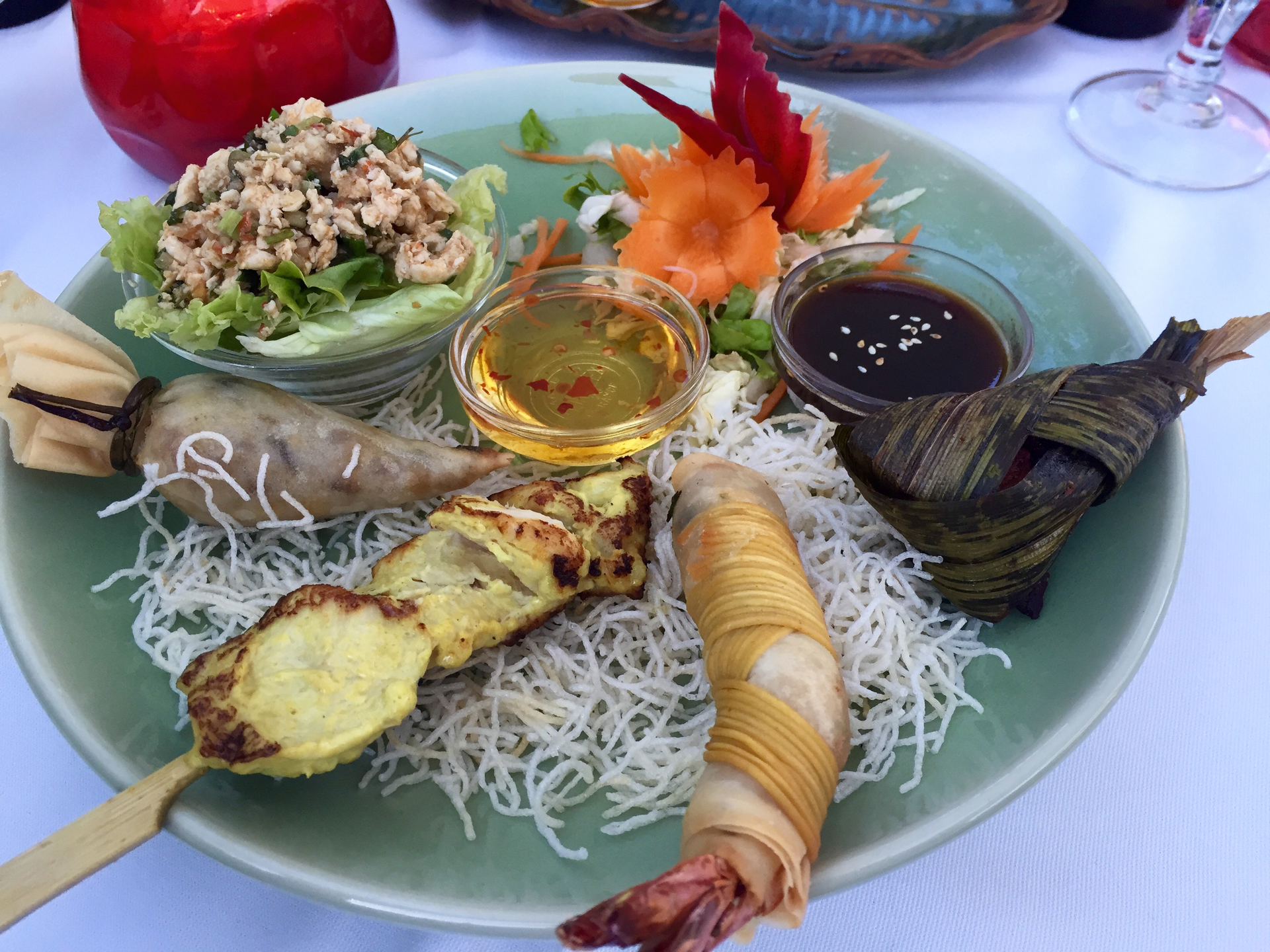 Overhead flat-lay of all ingredients for Fragrant Malay Nasi Kerabu with Herbal Grilled Fish laid out on a kitchen surface.