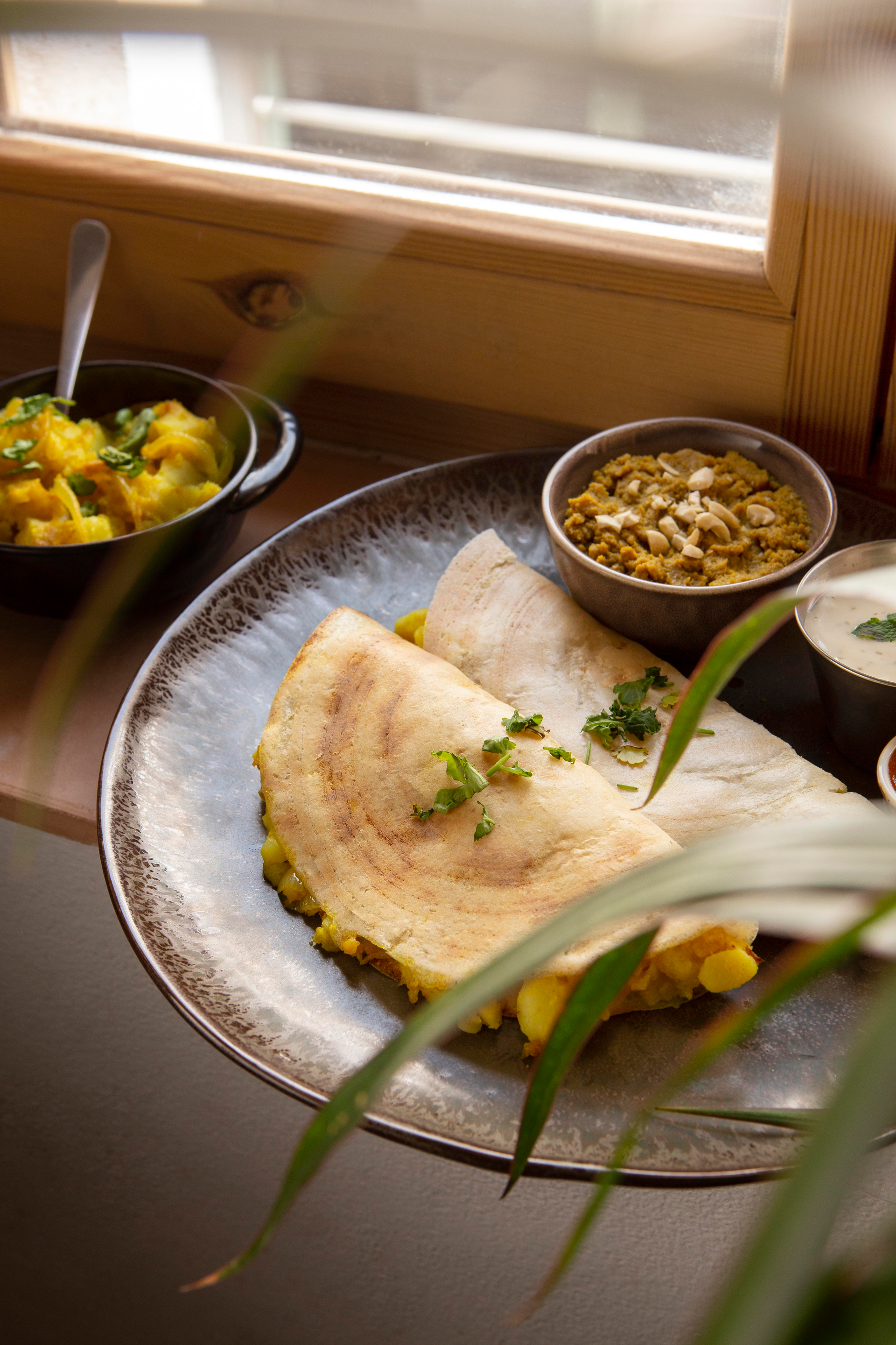 Overhead flat-lay of all ingredients for Fragrant Mauritian Dholl Puri Roti with Curry Vegetables laid out on a kitchen surface.