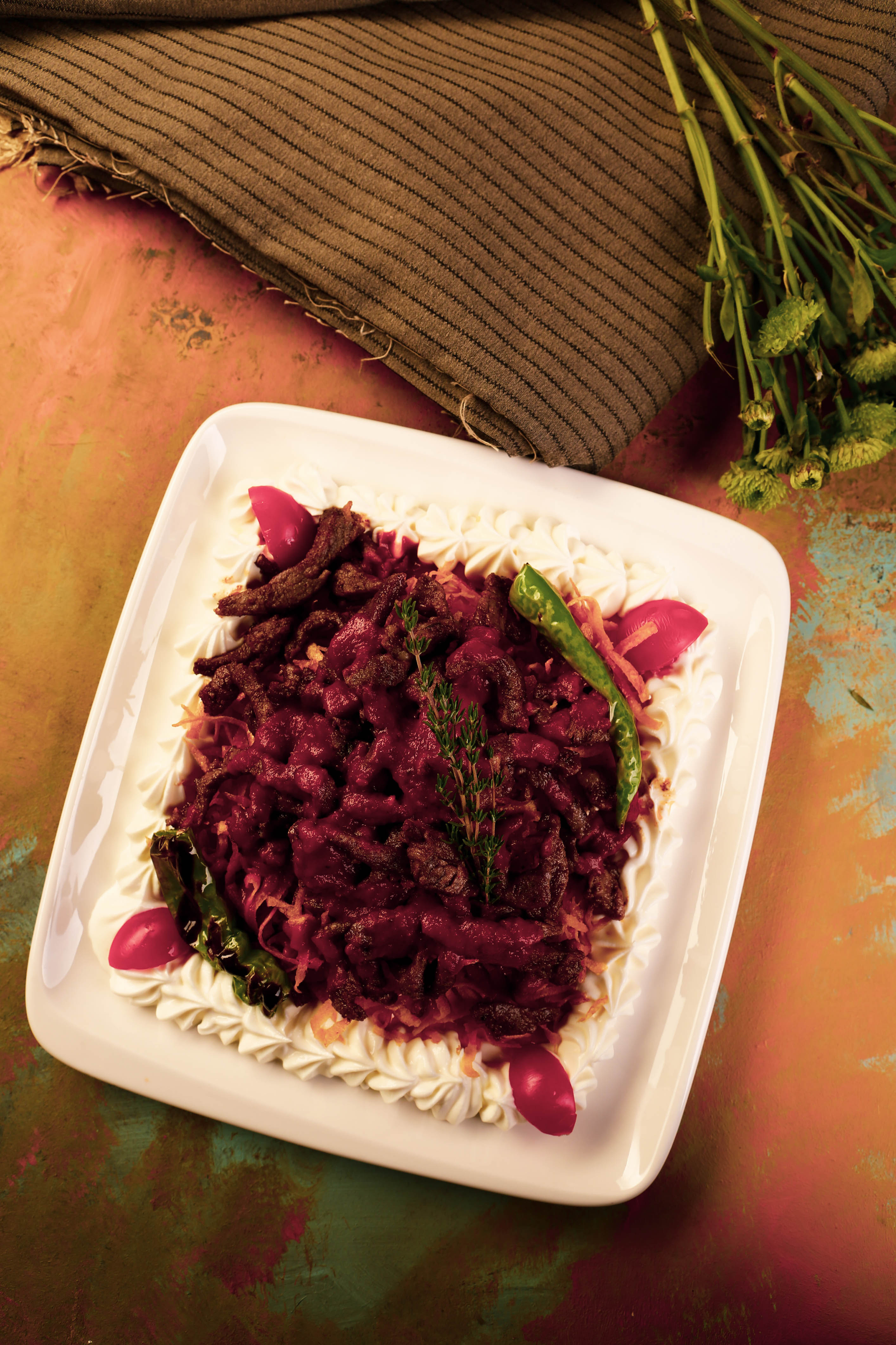 Overhead flat-lay of all ingredients for Fragrant Syrian Kebab Bil Karaz with Pomegranate Sauce laid out on a kitchen surface.