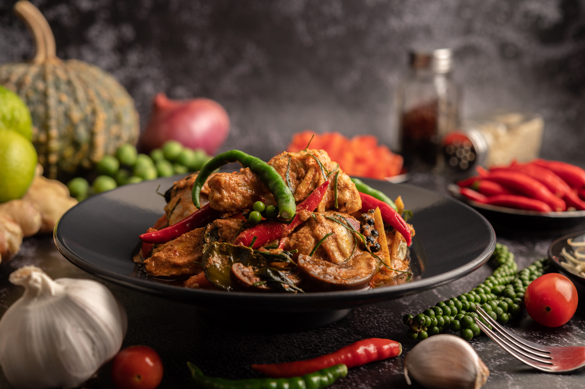Overhead flat-lay of all ingredients for Fragrant Thai Basil Stir-Fried Duck with Red Chili laid out on a kitchen surface.