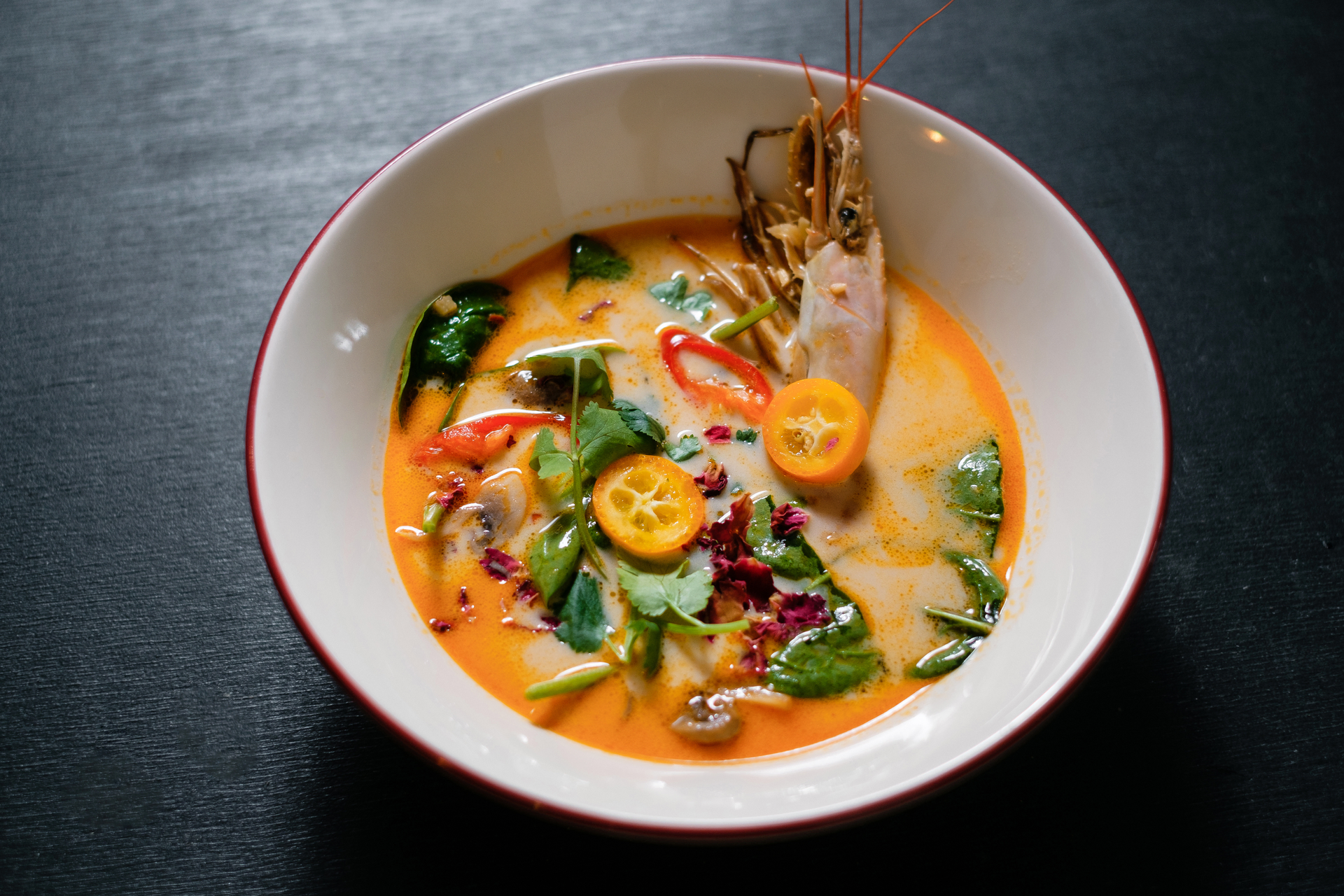 Overhead flat-lay of all ingredients for Fragrant Thai Coconut Lime Soup with Seafood Medley laid out on a kitchen surface.