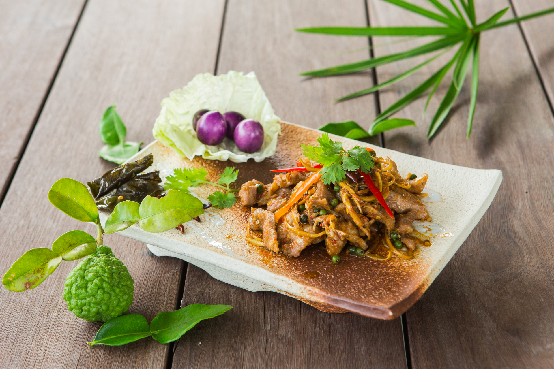 Overhead flat-lay of all ingredients for Fragrant Thai Waterfall Pork with Lime and Mint Marinade laid out on a kitchen surface.