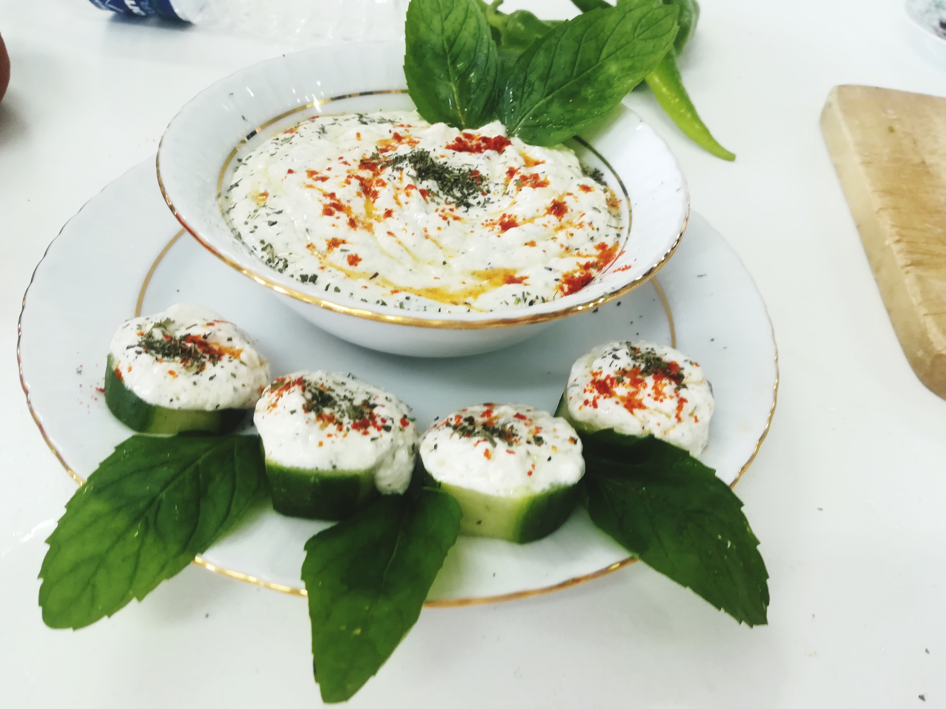 Overhead flat-lay of all ingredients for Fragrant Tunisian Lablabi with Coriander Yogurt Drizzle laid out on a kitchen surface.