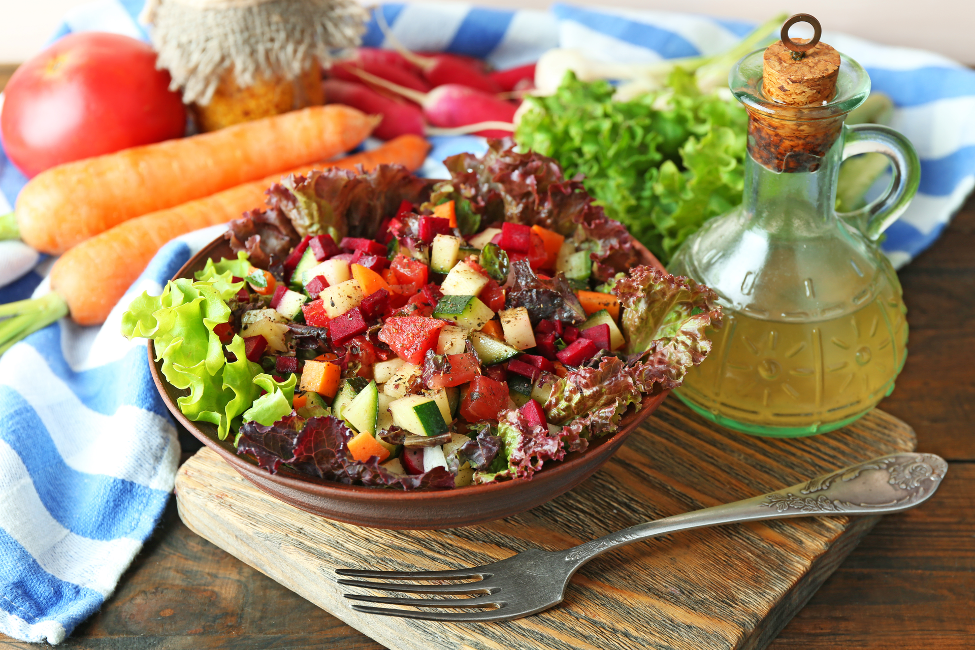 Overhead flat-lay of all ingredients for Fragrant Tunisian Mechouia Salad with Grilled Vegetables laid out on a kitchen surface.