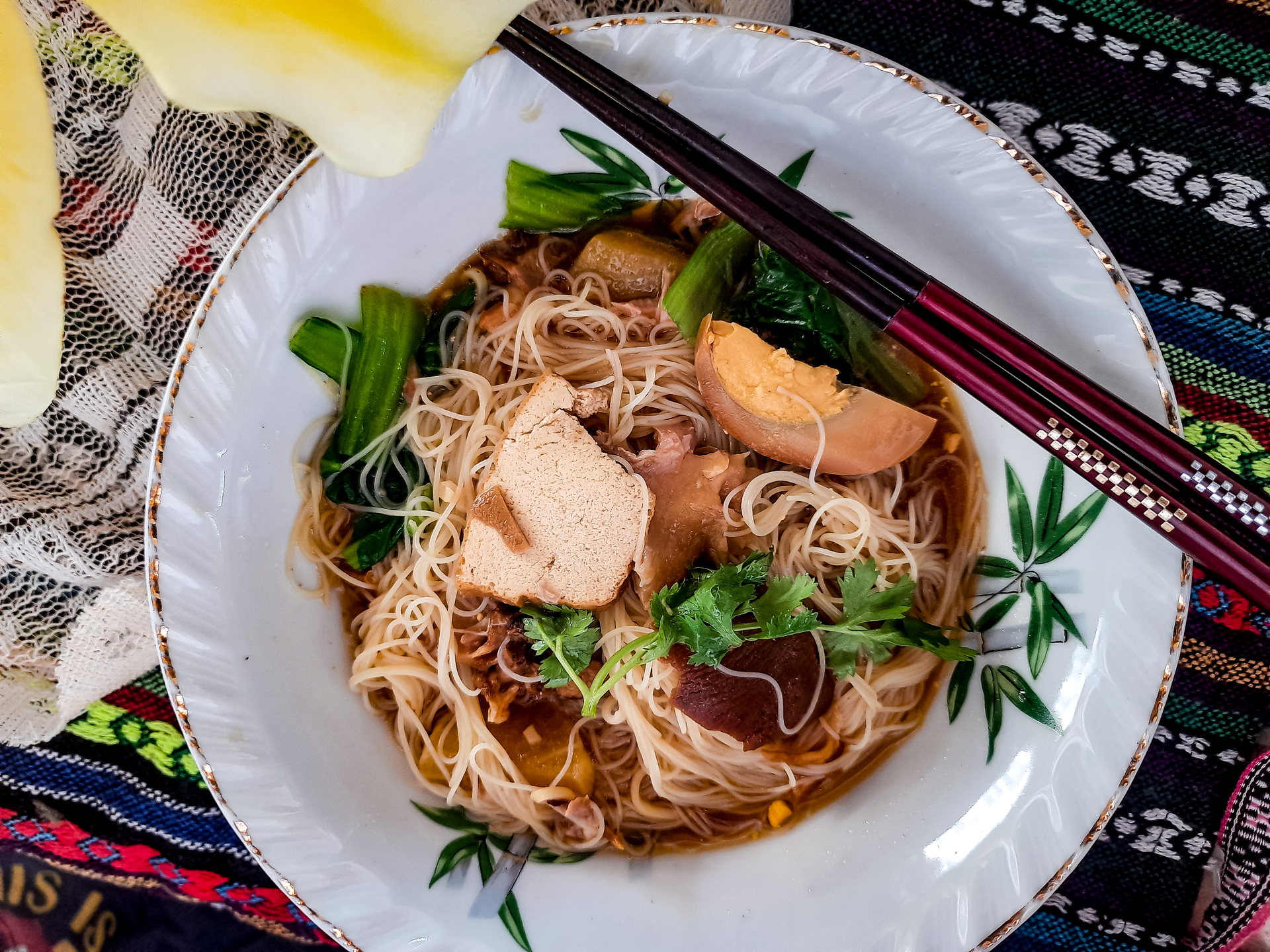Overhead flat-lay of all ingredients for Fragrant Vietnamese Cao Lau with Pork and Herbs laid out on a kitchen surface.