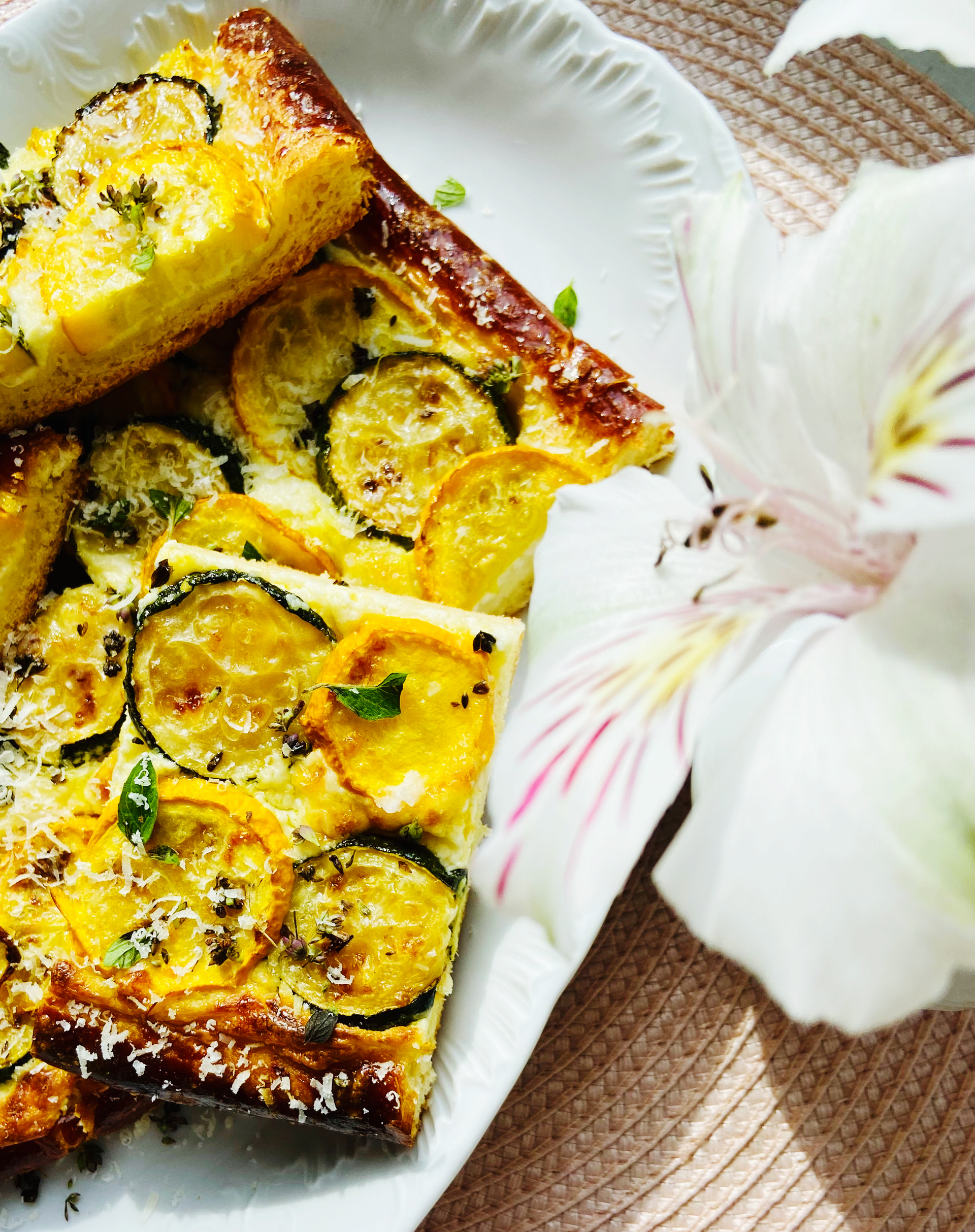 Overhead flat-lay of all ingredients for French Caramelized Onion and Gruyère Tart with Thyme laid out on a kitchen surface.