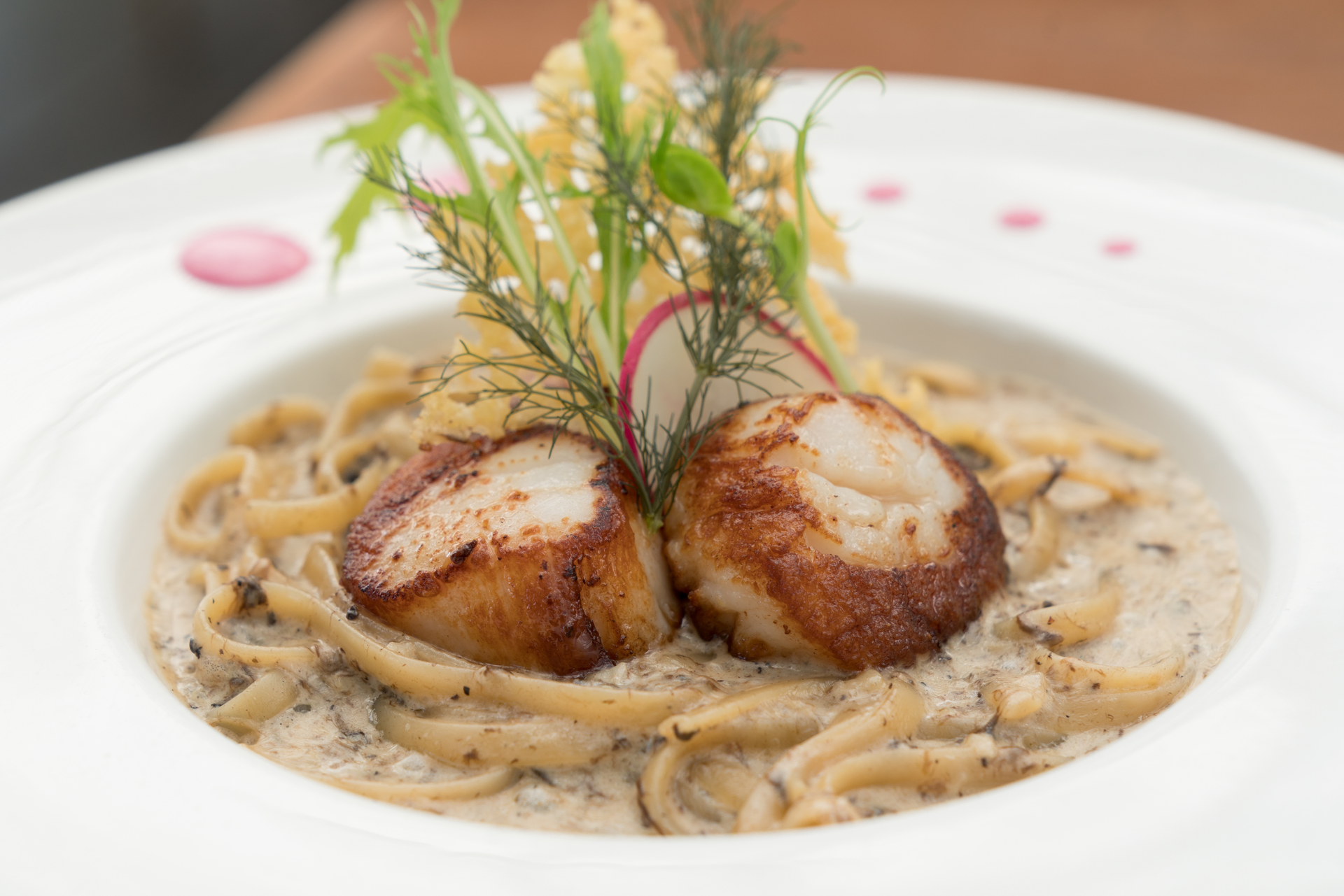Overhead flat-lay of all ingredients for French Coquilles Saint-Jacques with White Wine Cream Sauce laid out on a kitchen surface.