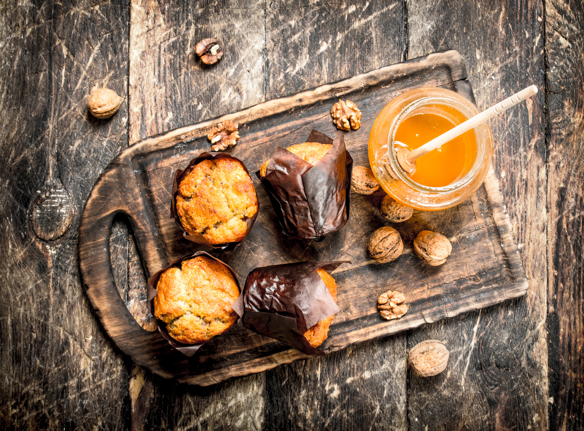 Overhead flat-lay of all ingredients for French Hazelnut and Orange Madeleines with Honey Glaze laid out on a kitchen surface.