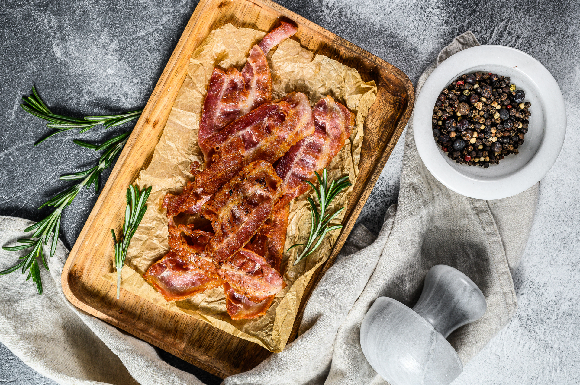 Overhead flat-lay of all ingredients for French Tarte Flambée with Onions and Bacon laid out on a kitchen surface.
