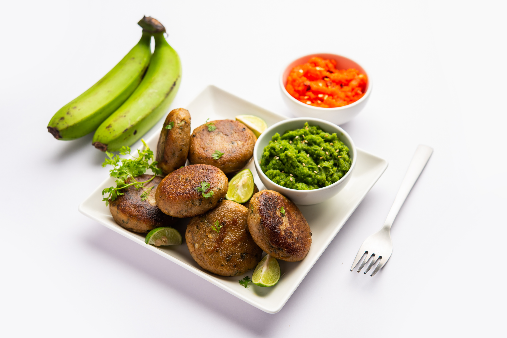 Overhead flat-lay of all ingredients for Ghanaian Waakye with Fried Plantains laid out on a kitchen surface.