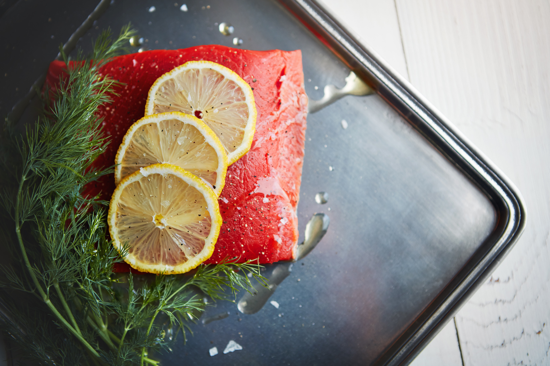Overhead flat-lay of all ingredients for Glacial Icelandic Arctic Char Gravlax with Dill-Citrus Cure laid out on a kitchen surface.
