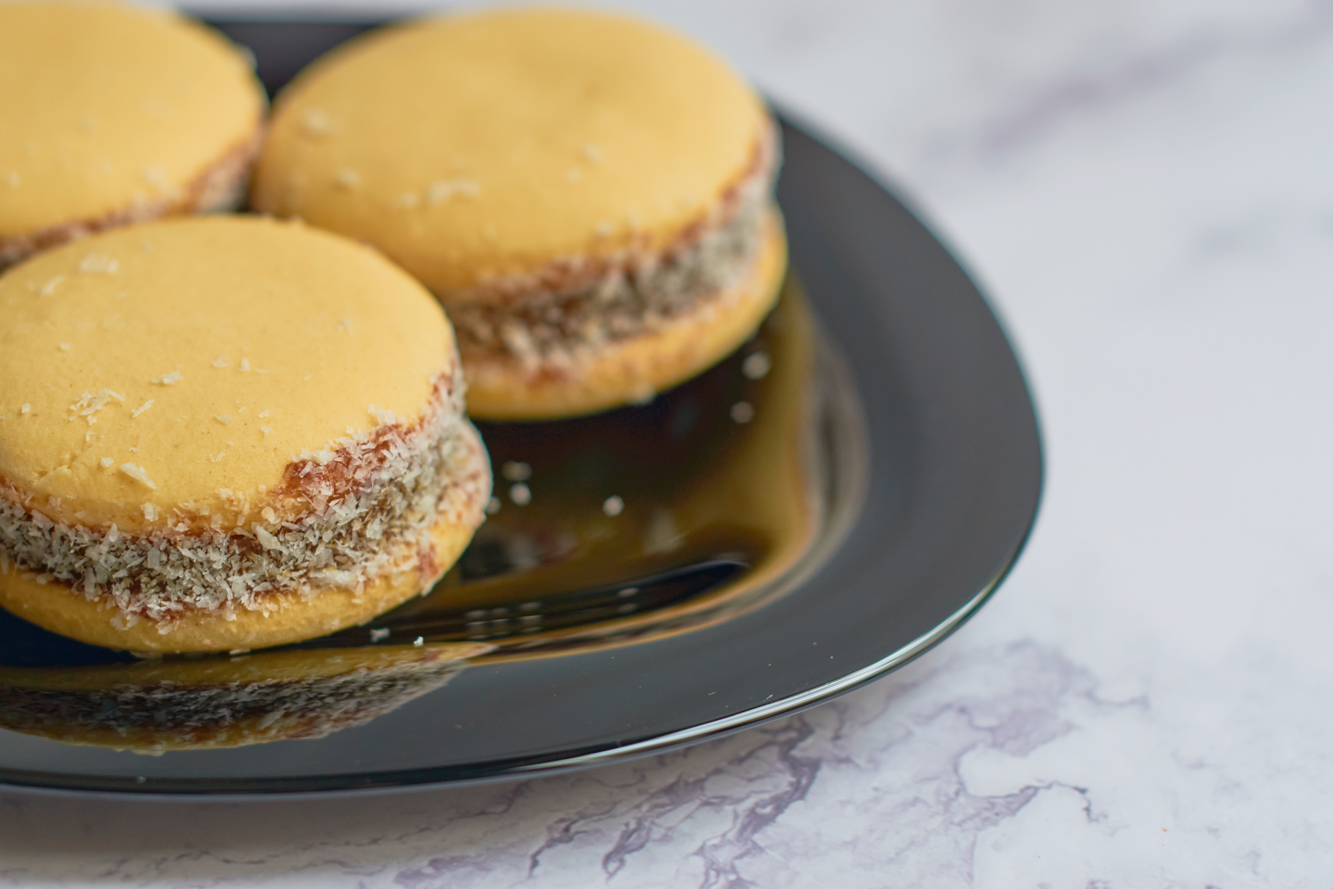 Overhead flat-lay of all ingredients for Glazed Peruvian Alfajores with Honey-Caramel Center laid out on a kitchen surface.