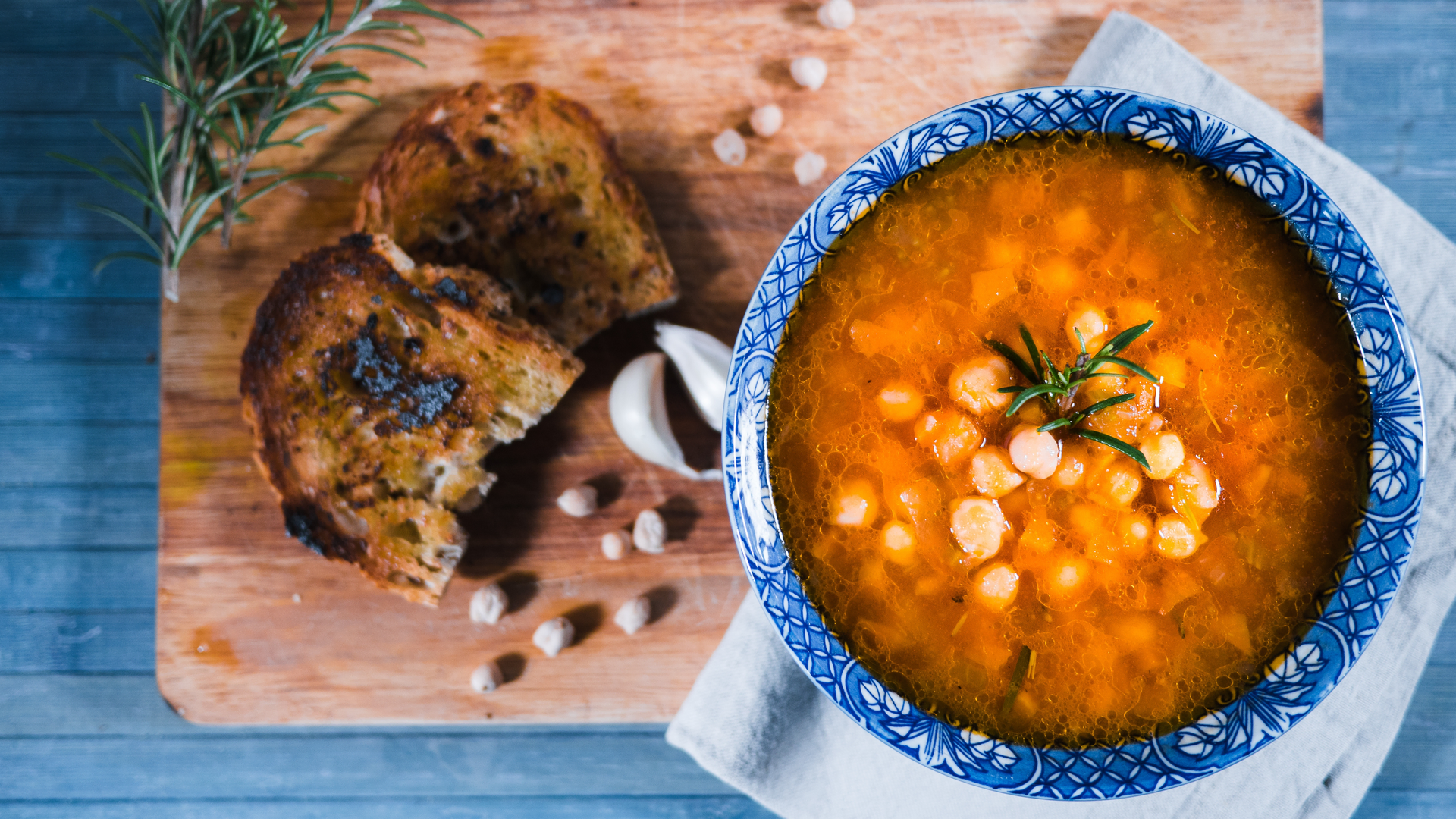 Overhead flat-lay of all ingredients for Greek Fasolada Soup laid out on a kitchen surface.