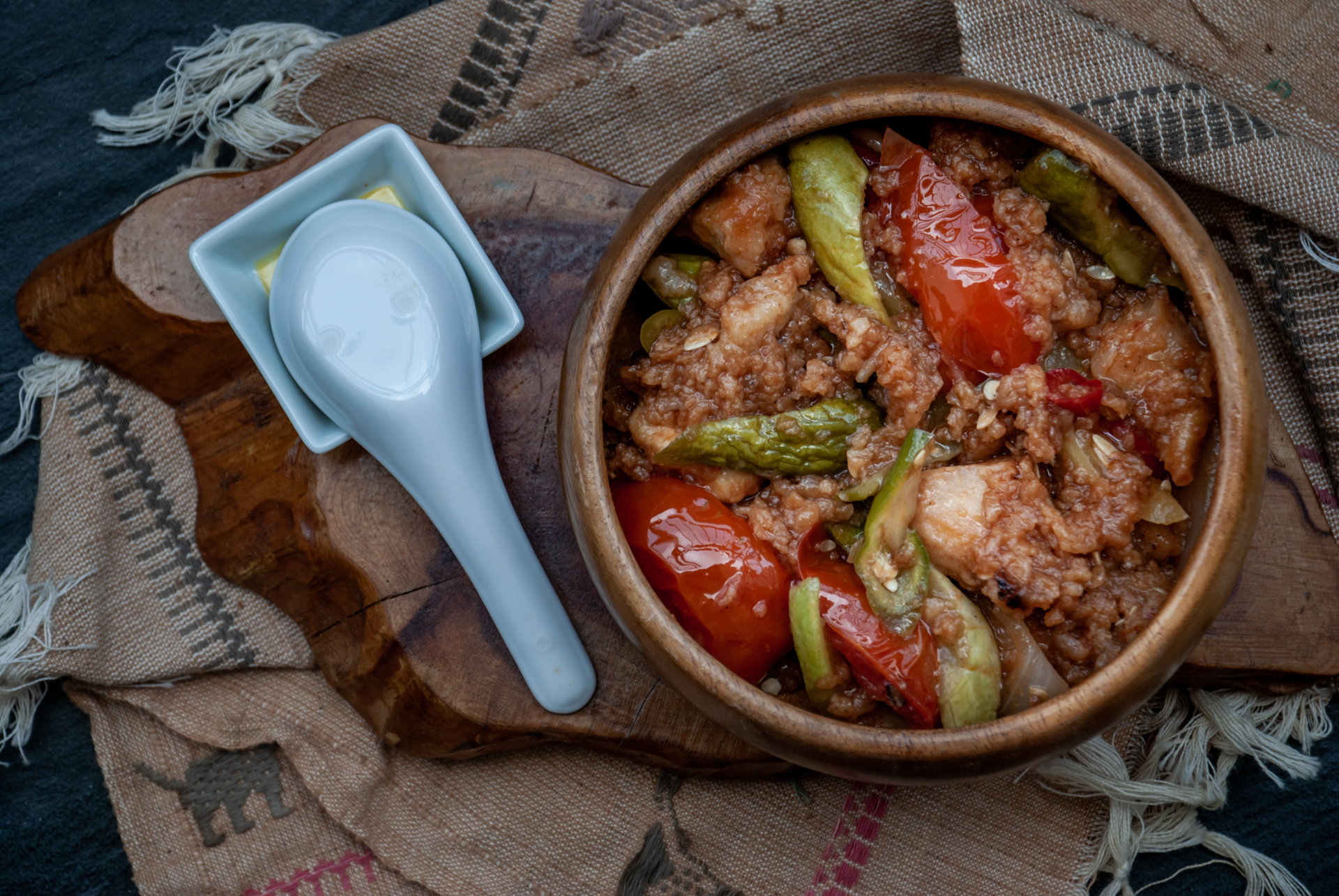 Overhead flat-lay of all ingredients for Greek Kokkinisto with Beef and Tomato Sauce laid out on a kitchen surface.