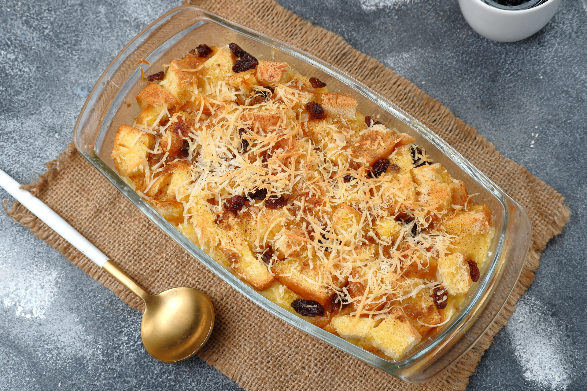 Overhead flat-lay of all ingredients for Greek Pastitsio with Cinnamon Béchamel laid out on a kitchen surface.