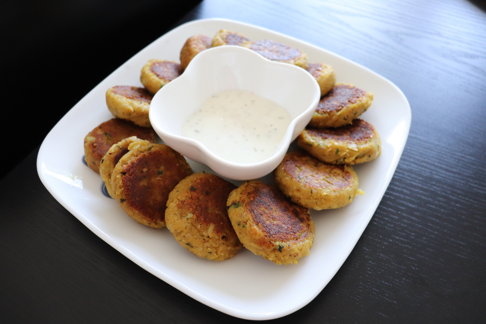 Overhead flat-lay of all ingredients for Greek Roasted Eggplant Fritters with Ouzo Dipping Sauce laid out on a kitchen surface.