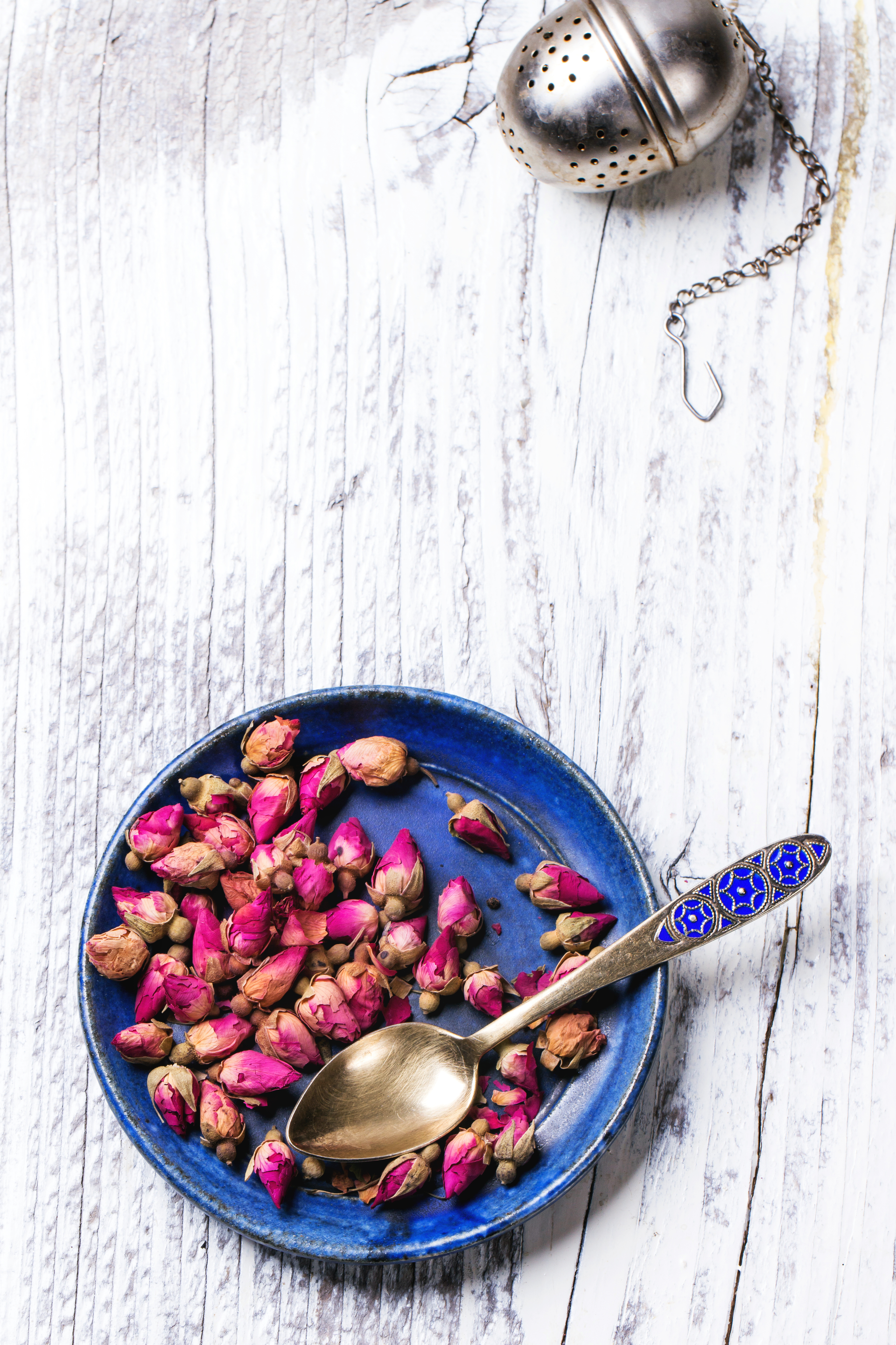Overhead flat-lay of all ingredients for Greek Rose Petal Spoon Sweet with Almonds laid out on a kitchen surface.