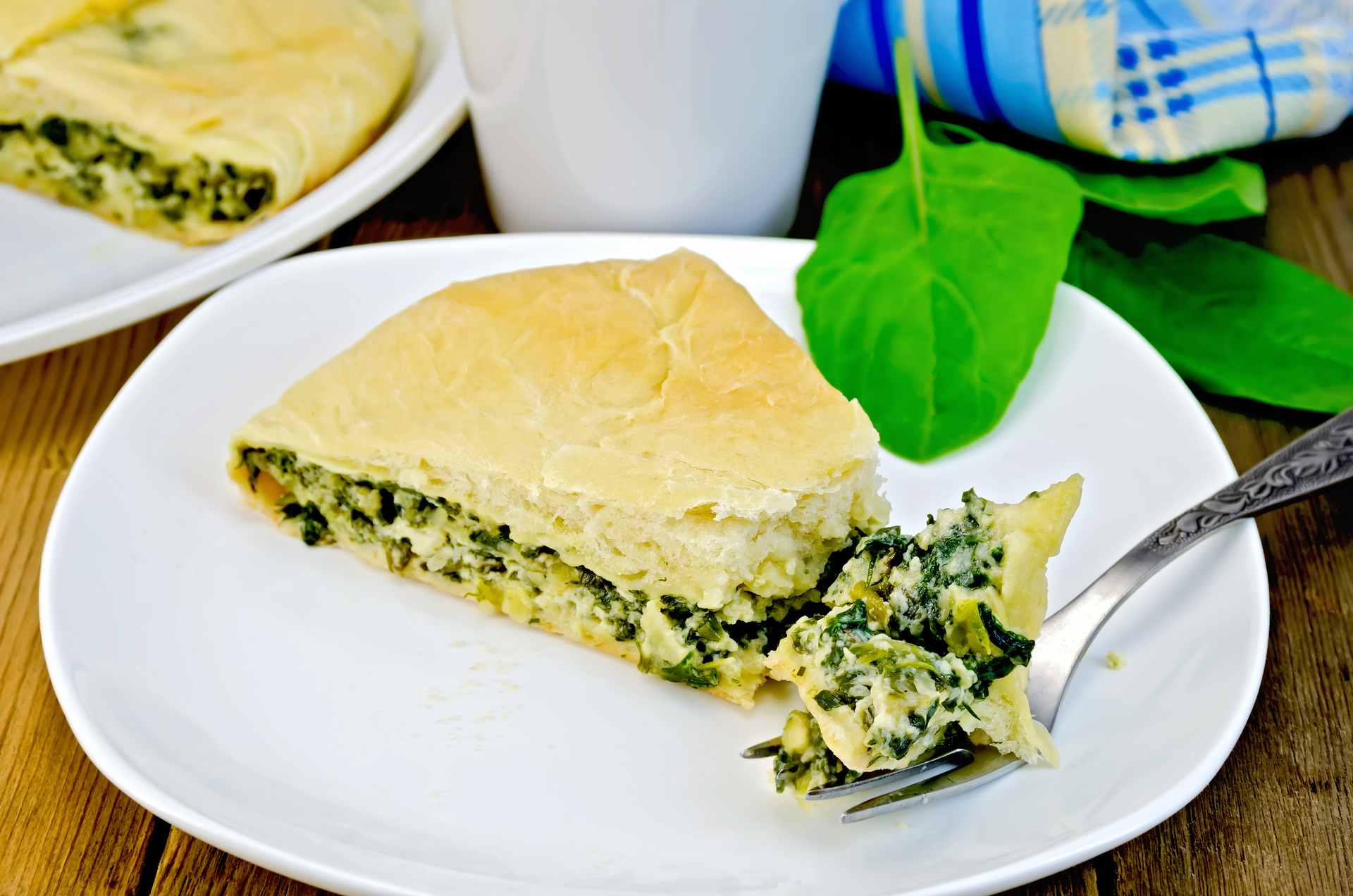 Overhead flat-lay of all ingredients for Greek Spanakopita with Feta and Spinach laid out on a kitchen surface.