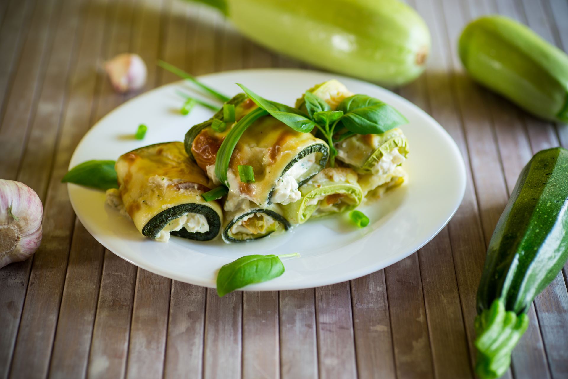 Overhead flat-lay of all ingredients for Greek Zucchini Blossoms Stuffed with Feta and Herbs laid out on a kitchen surface.