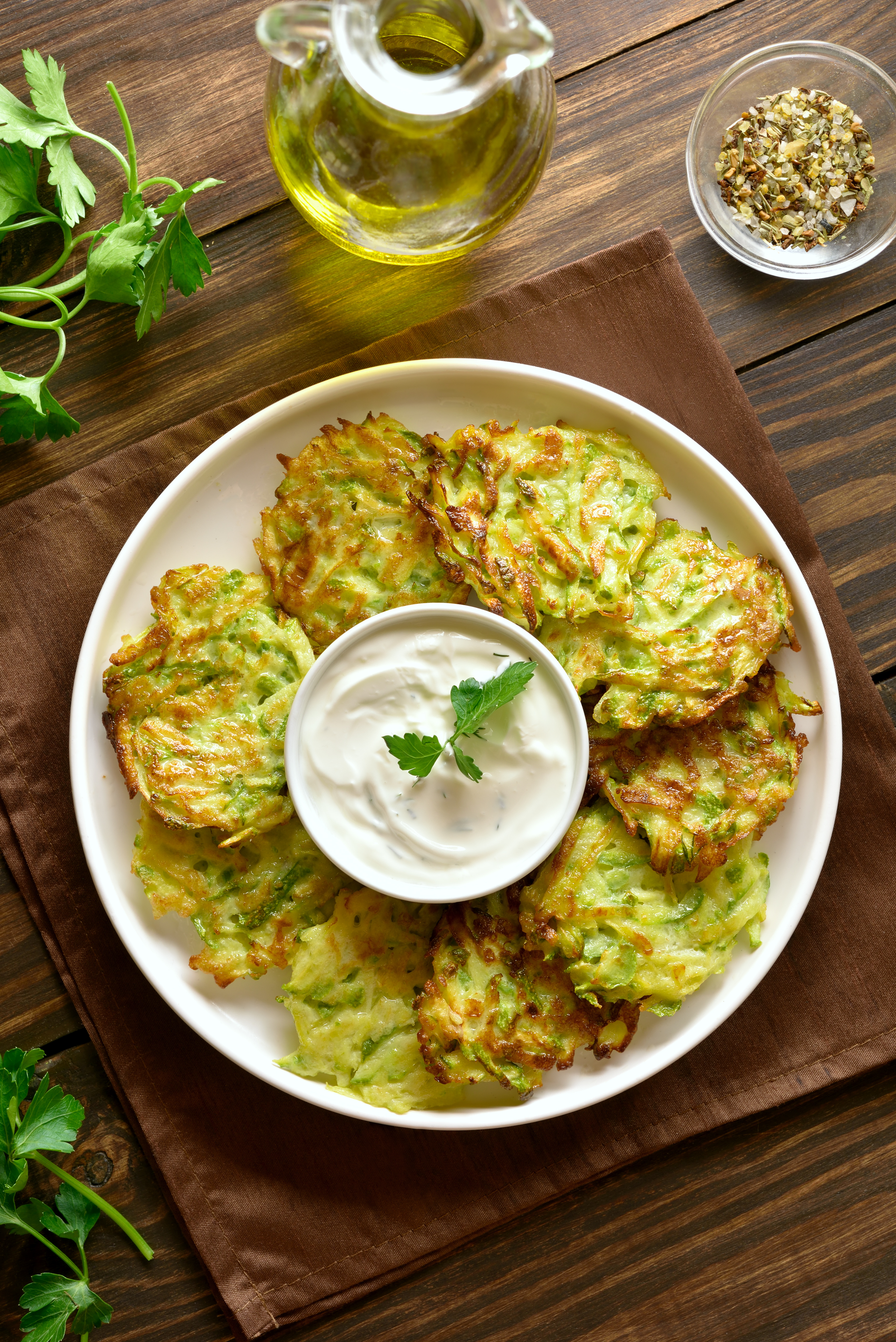 Greek Zucchini Fritters with Lemon Tzatziki Sauce — Appetizer served and photographed from above
