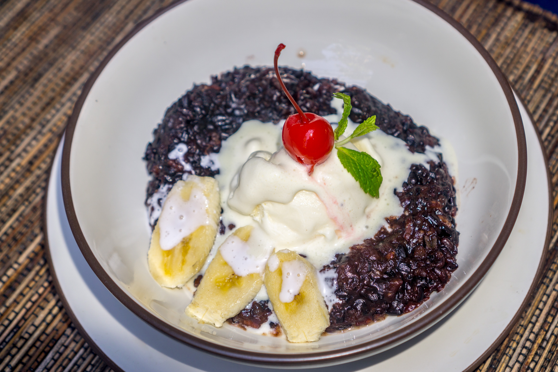Guyanese Black Pudding with Casareep-Boiled Rice — Main Course served and photographed from above