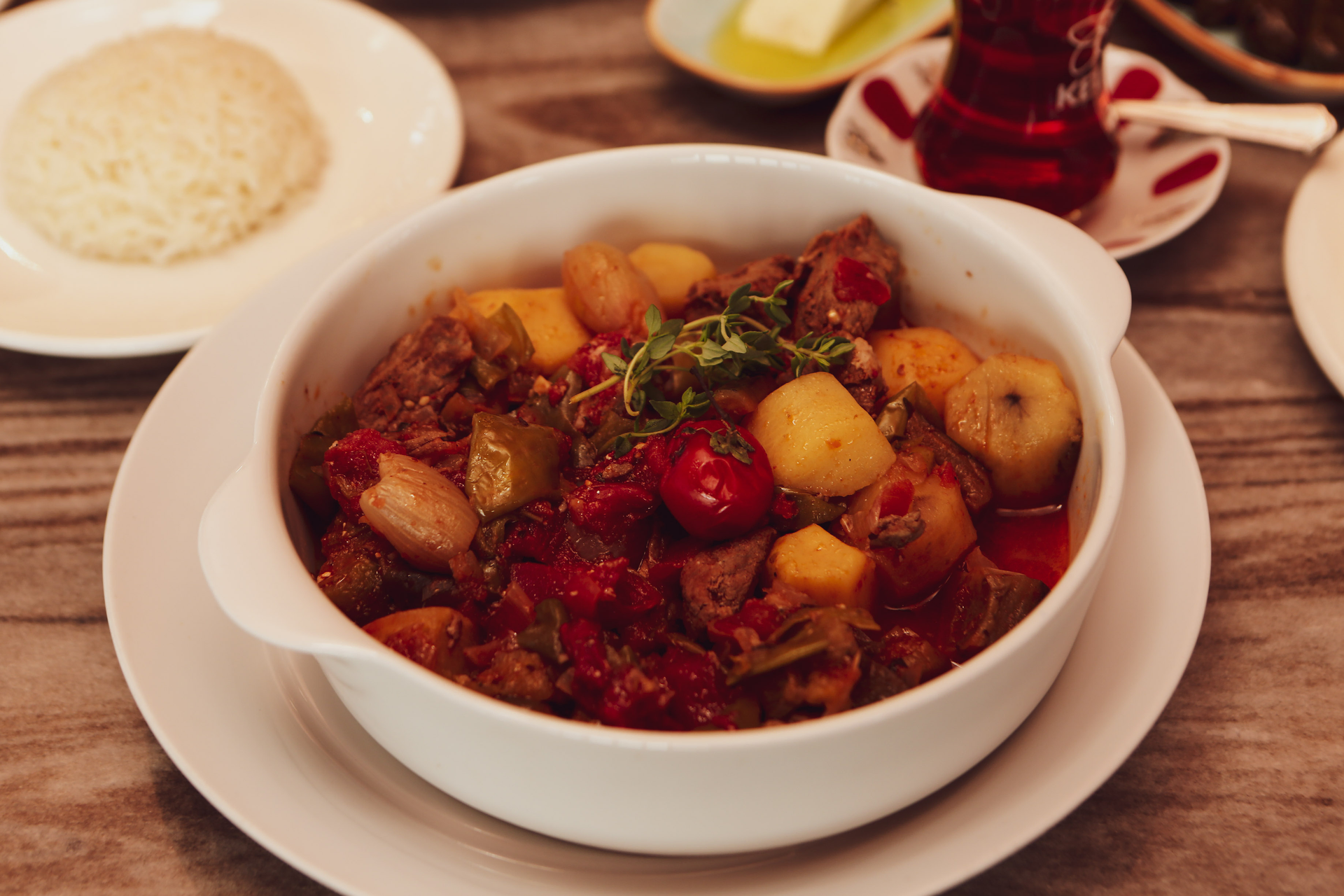 Overhead flat-lay of all ingredients for Guyanese Pepper Pot Stew with Cassareep and Tamarind laid out on a kitchen surface.