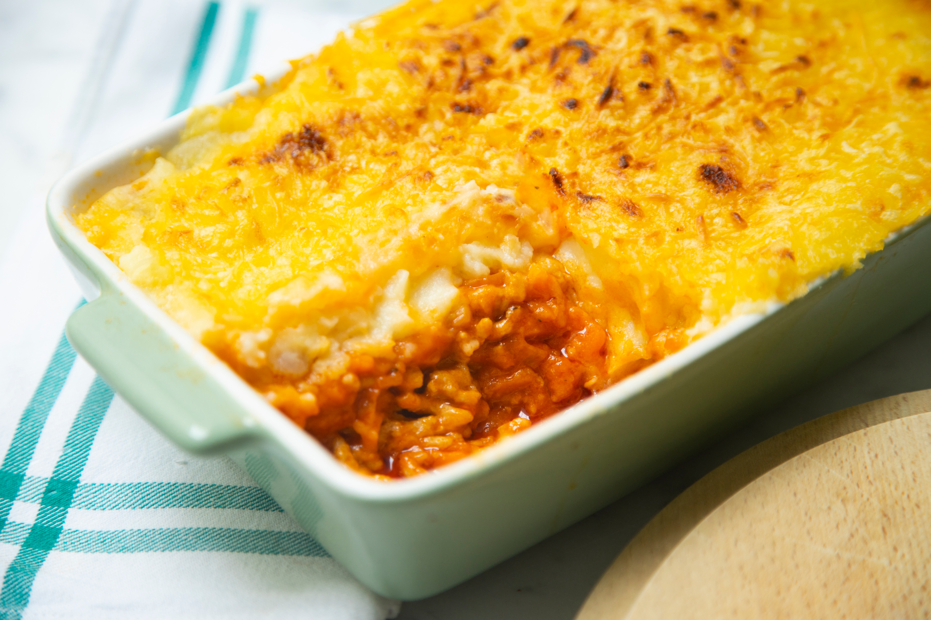 Overhead flat-lay of all ingredients for Hearty American Cornbread Chili Casserole with Cheddar Crumble laid out on a kitchen surface.