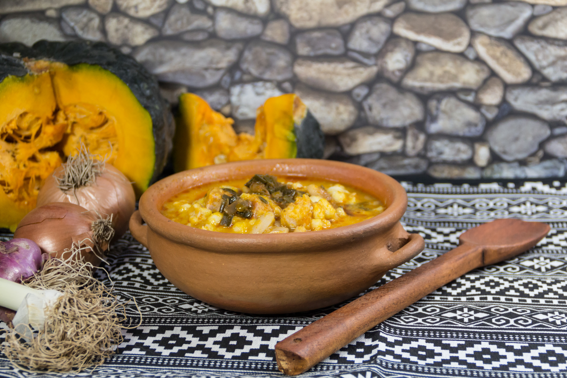 Overhead flat-lay of all ingredients for Hearty Argentine Locro with Squash and Corn laid out on a kitchen surface.