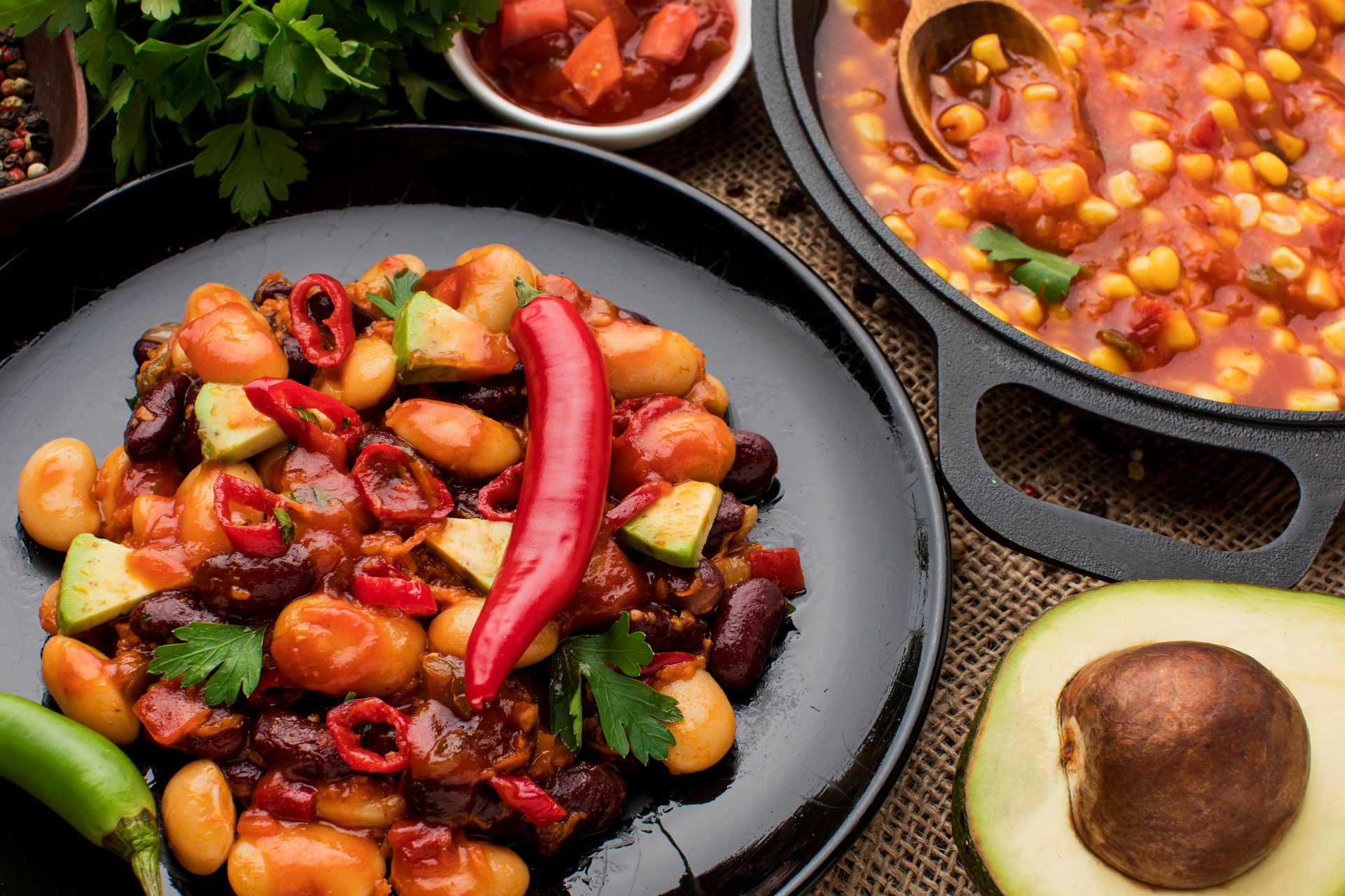 Overhead flat-lay of all ingredients for Hearty Bolivian Fricasé with Hominy and Chili laid out on a kitchen surface.