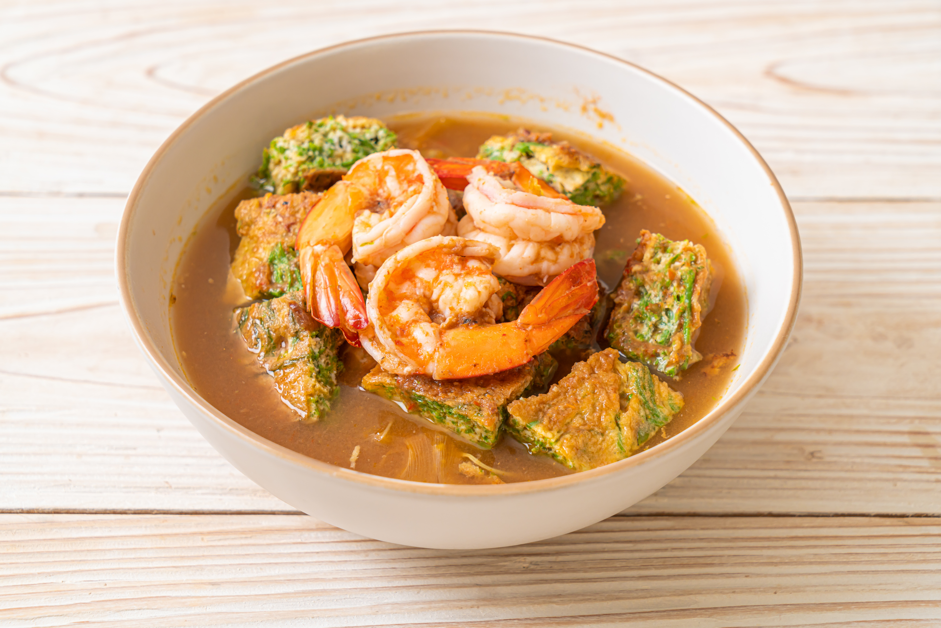 Overhead flat-lay of all ingredients for Hearty Filipino Kare-Kare with Peanuts and Shrimp Paste laid out on a kitchen surface.