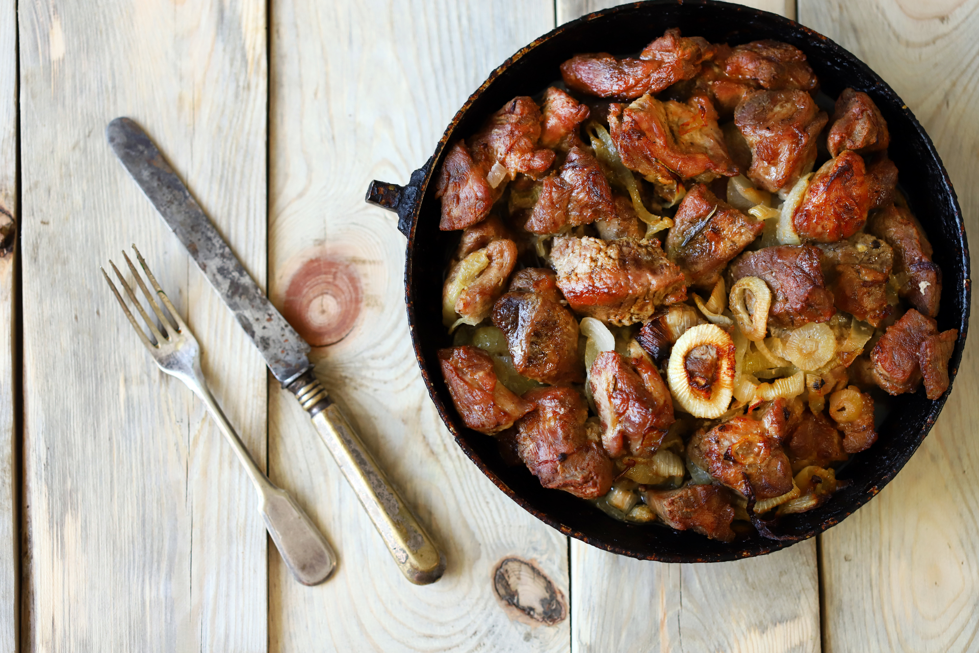 Overhead flat-lay of all ingredients for Hearty French Cassoulet with Duck Confit and Sausage laid out on a kitchen surface.
