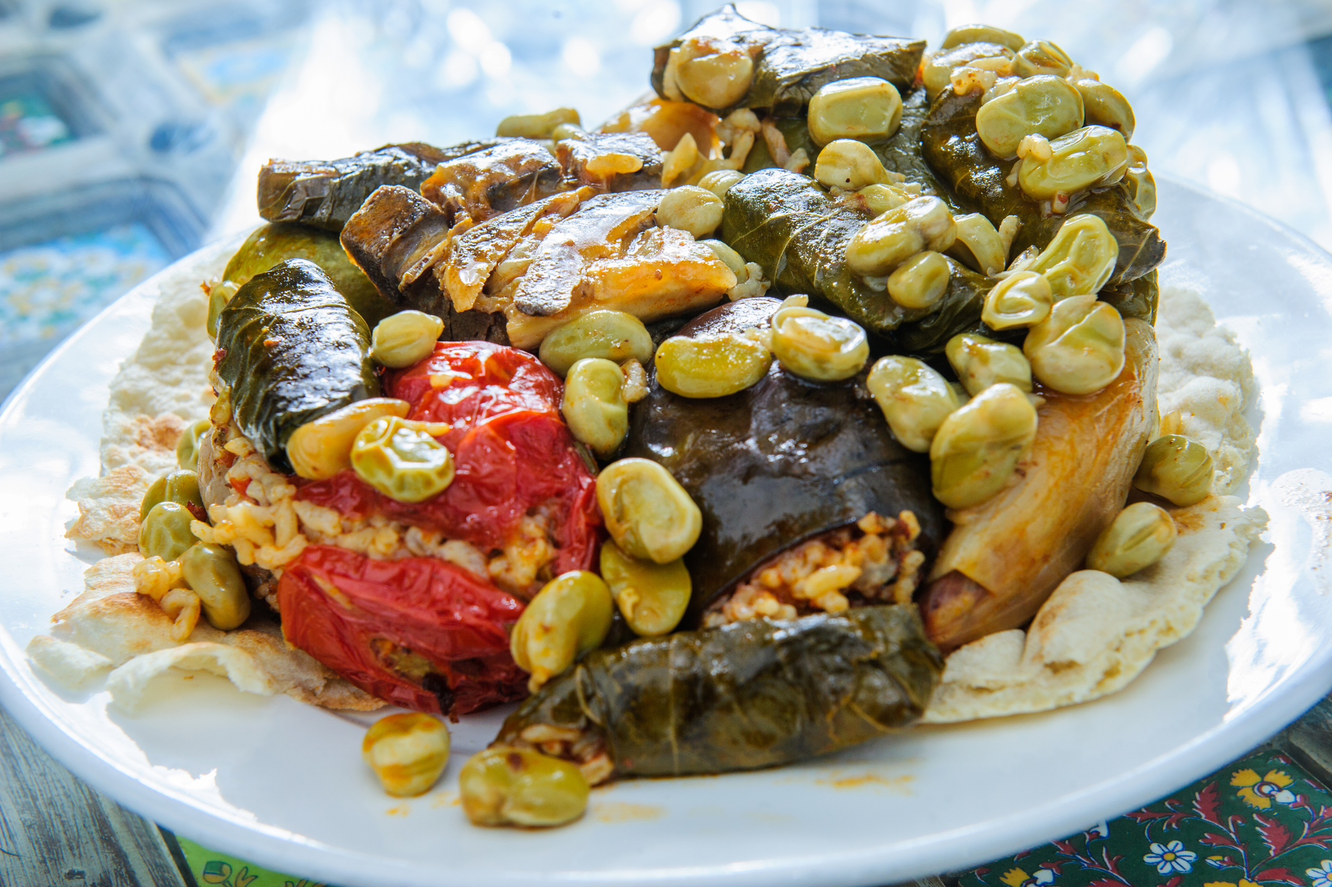 Overhead flat-lay of all ingredients for Hearty Moroccan Fish Tagine with Olives and Capers laid out on a kitchen surface.