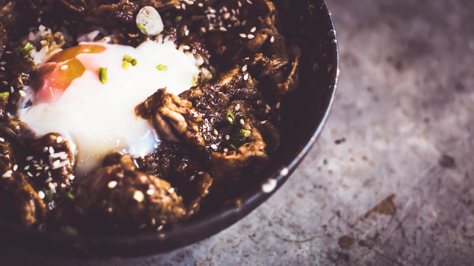 Overhead flat-lay of all ingredients for Hearty Scottish Stovies with MacSween Black Pudding laid out on a kitchen surface.