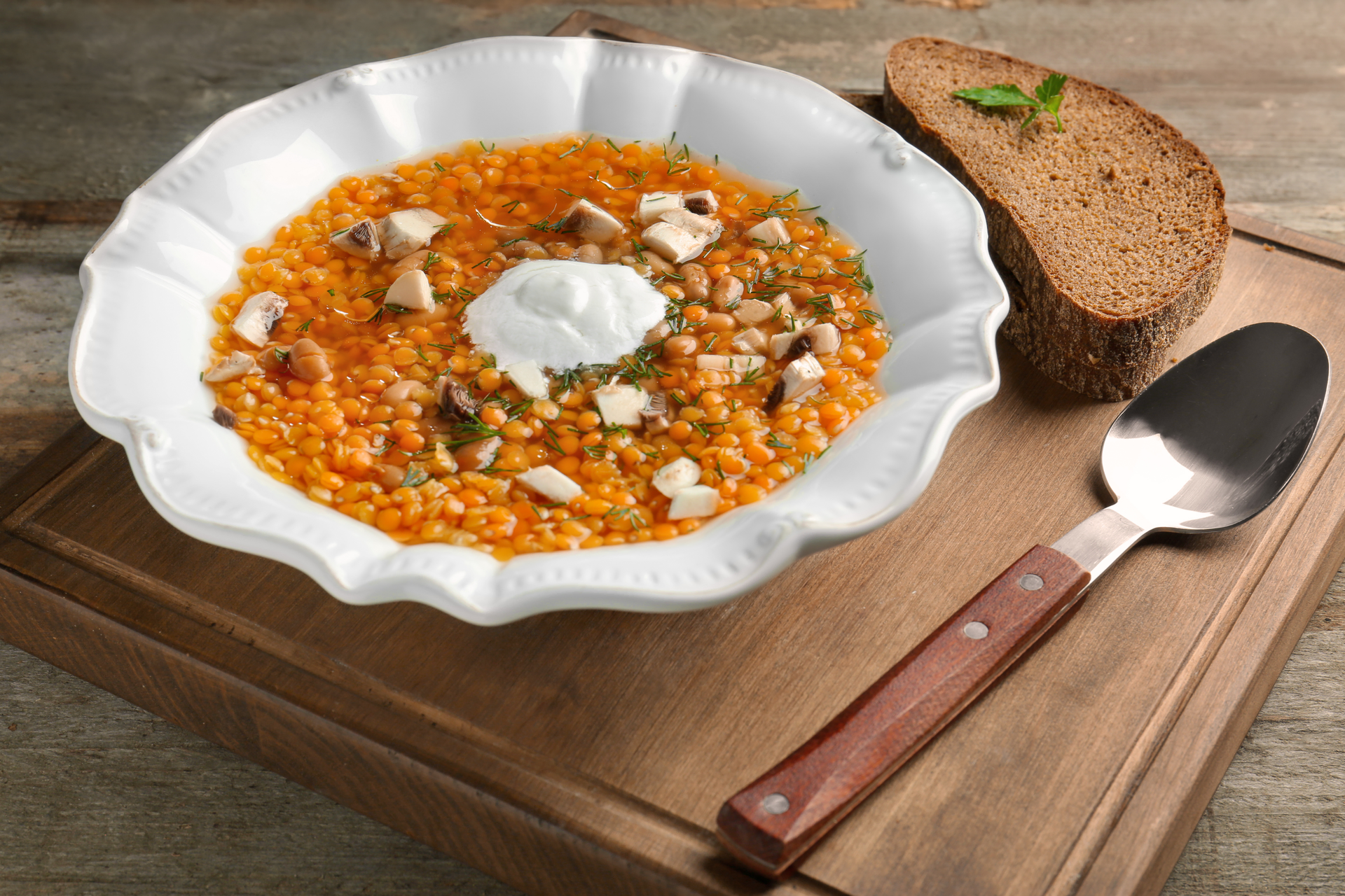 Overhead flat-lay of all ingredients for Hearty Turkish Lentil Soup with Bulgur and Mint laid out on a kitchen surface.