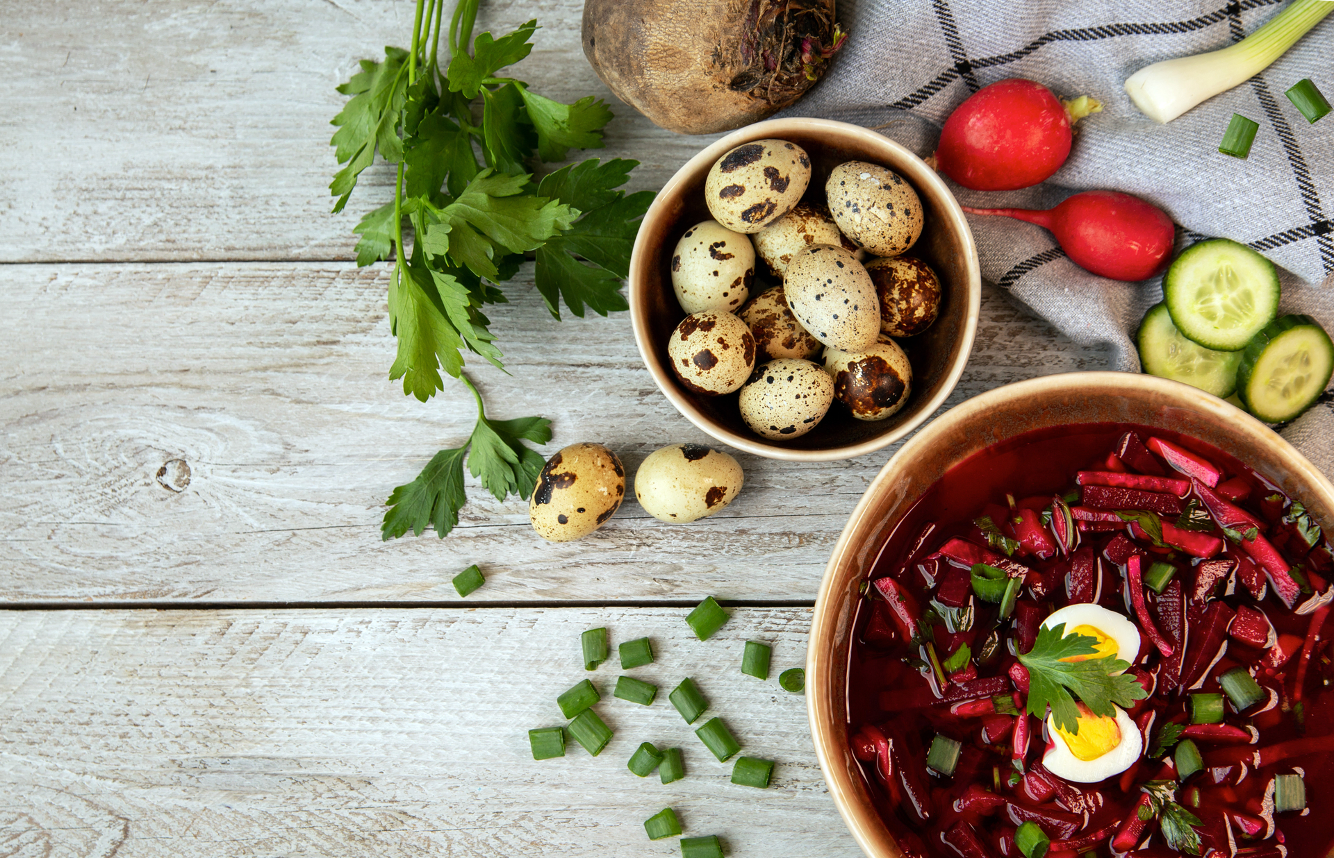 Overhead flat-lay of all ingredients for Hearty Ukrainian Borscht with Wild Mushrooms laid out on a kitchen surface.