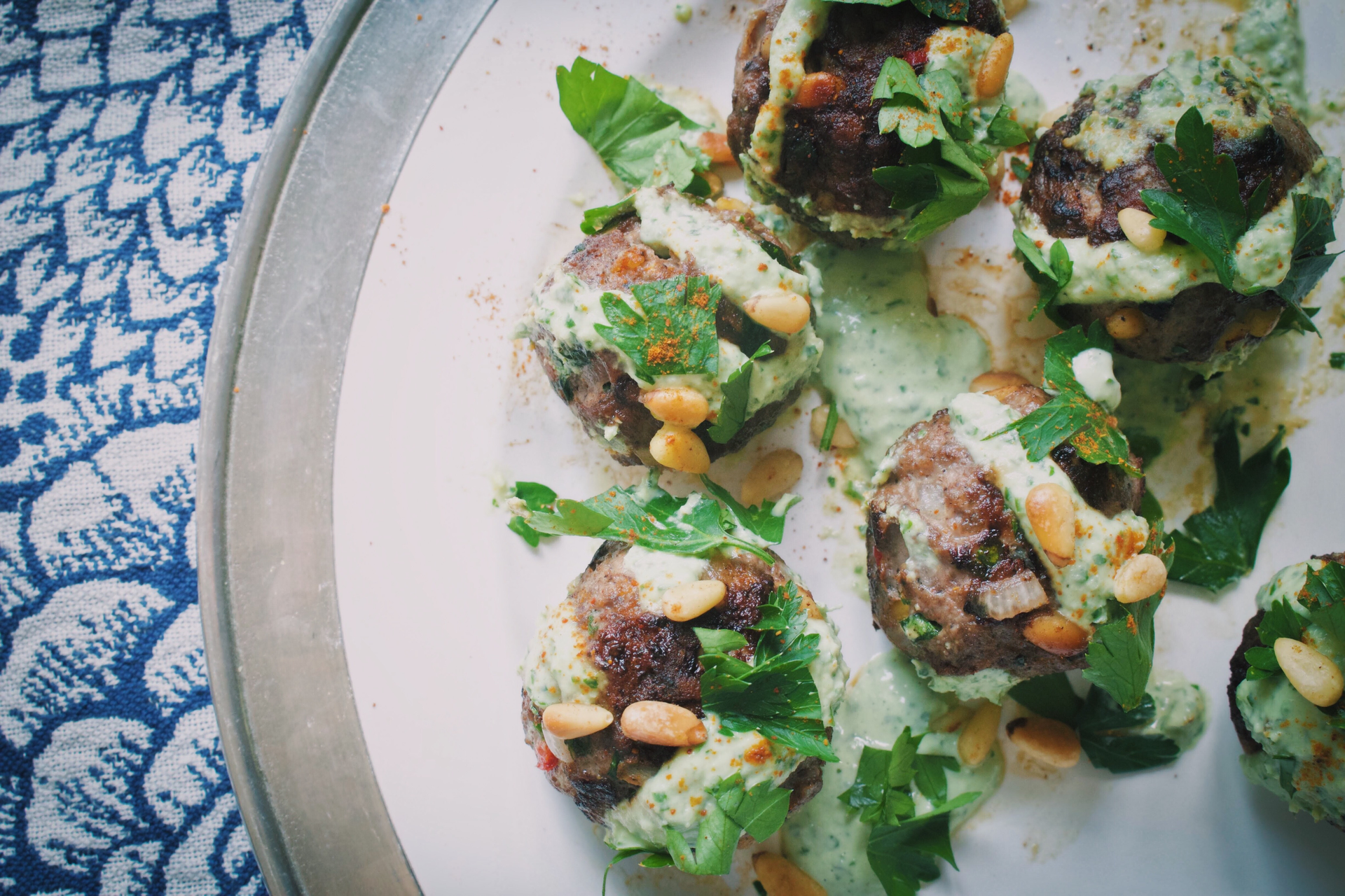 Overhead flat-lay of all ingredients for Herb-Crusted Greek Lamb Kotopoulo laid out on a kitchen surface.