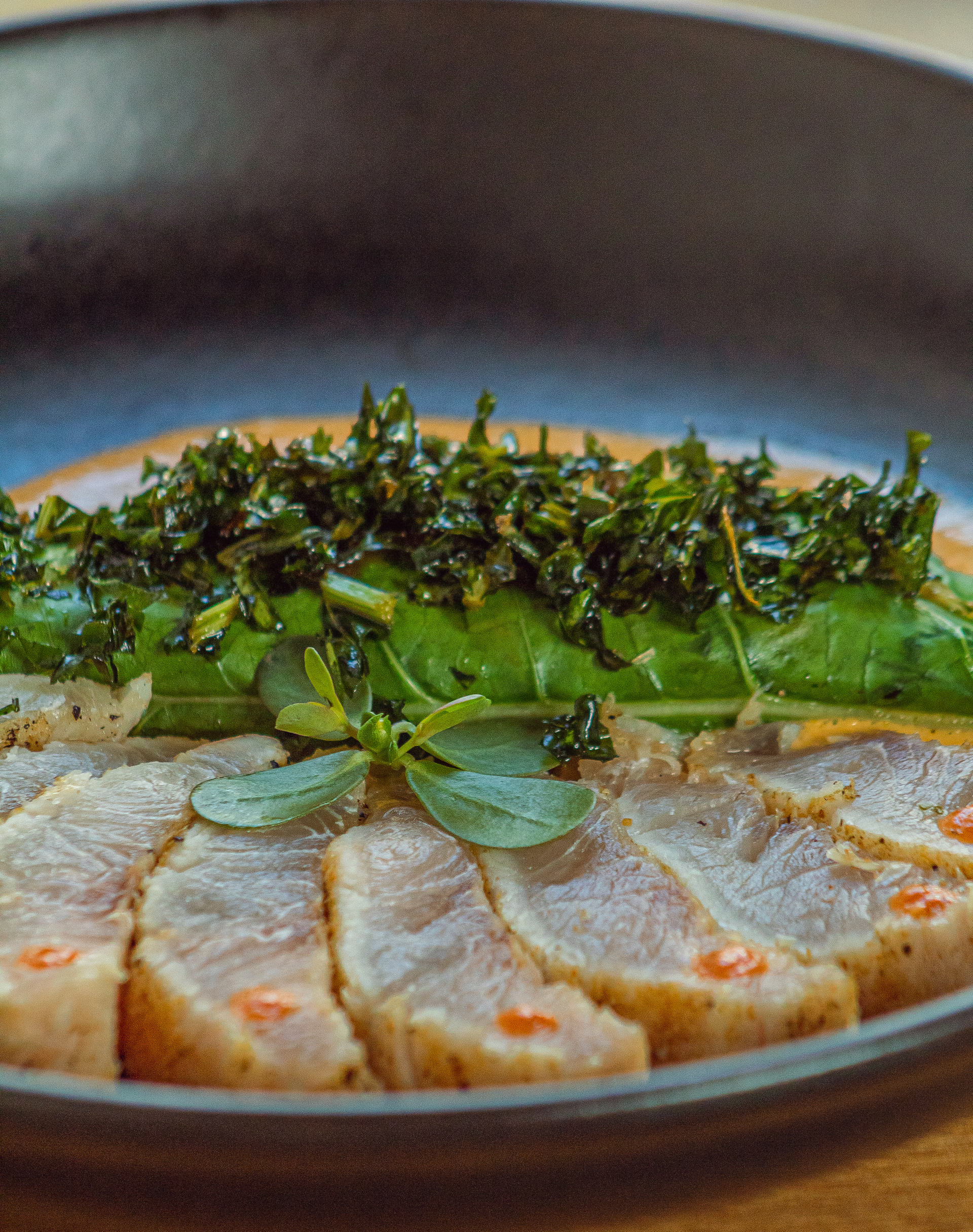Overhead flat-lay of all ingredients for Herb-Crusted Icelandic Cod with Dried Seaweed Garnish laid out on a kitchen surface.