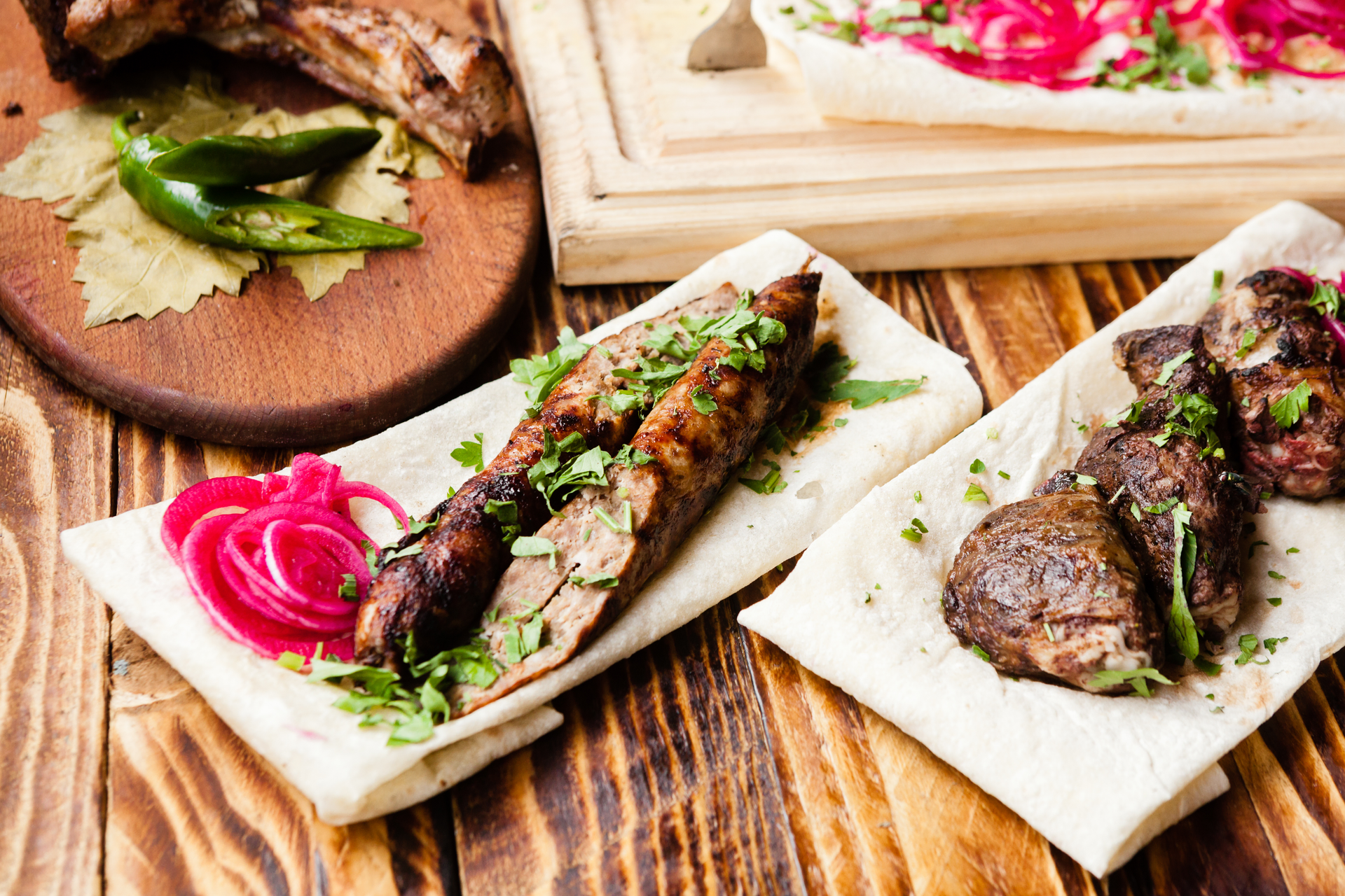 Overhead flat-lay of all ingredients for Herb-Infused Greek Lamb Souvlaki with Lemon Zest laid out on a kitchen surface.