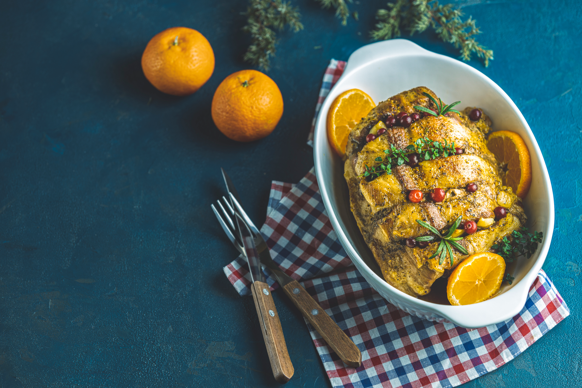 Overhead flat-lay of all ingredients for Herb-Roasted Chicken with Lemon and Garlic laid out on a kitchen surface.