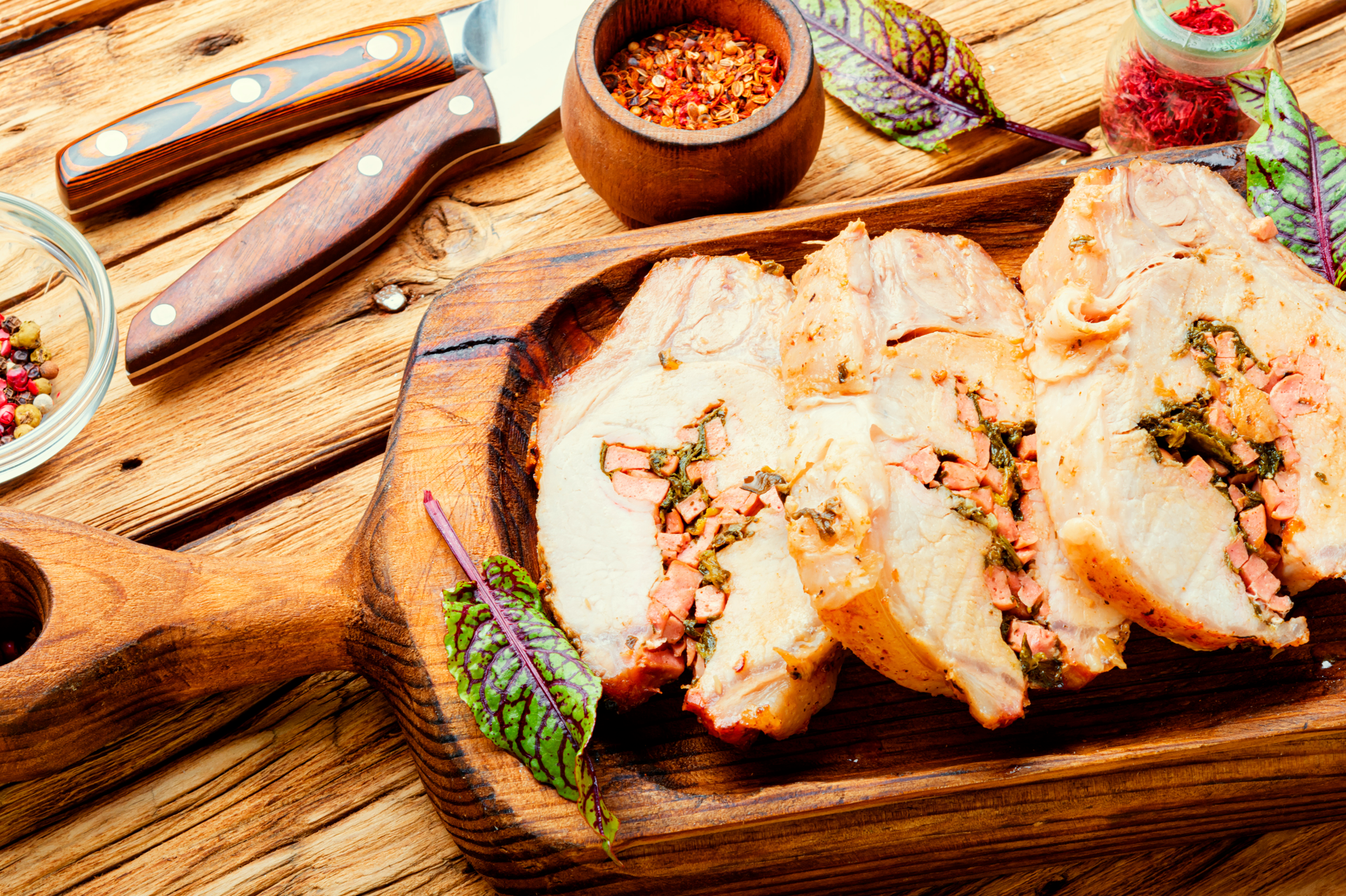 Overhead flat-lay of all ingredients for Herb-Roasted Italian Porchetta with Fennel and Garlic laid out on a kitchen surface.