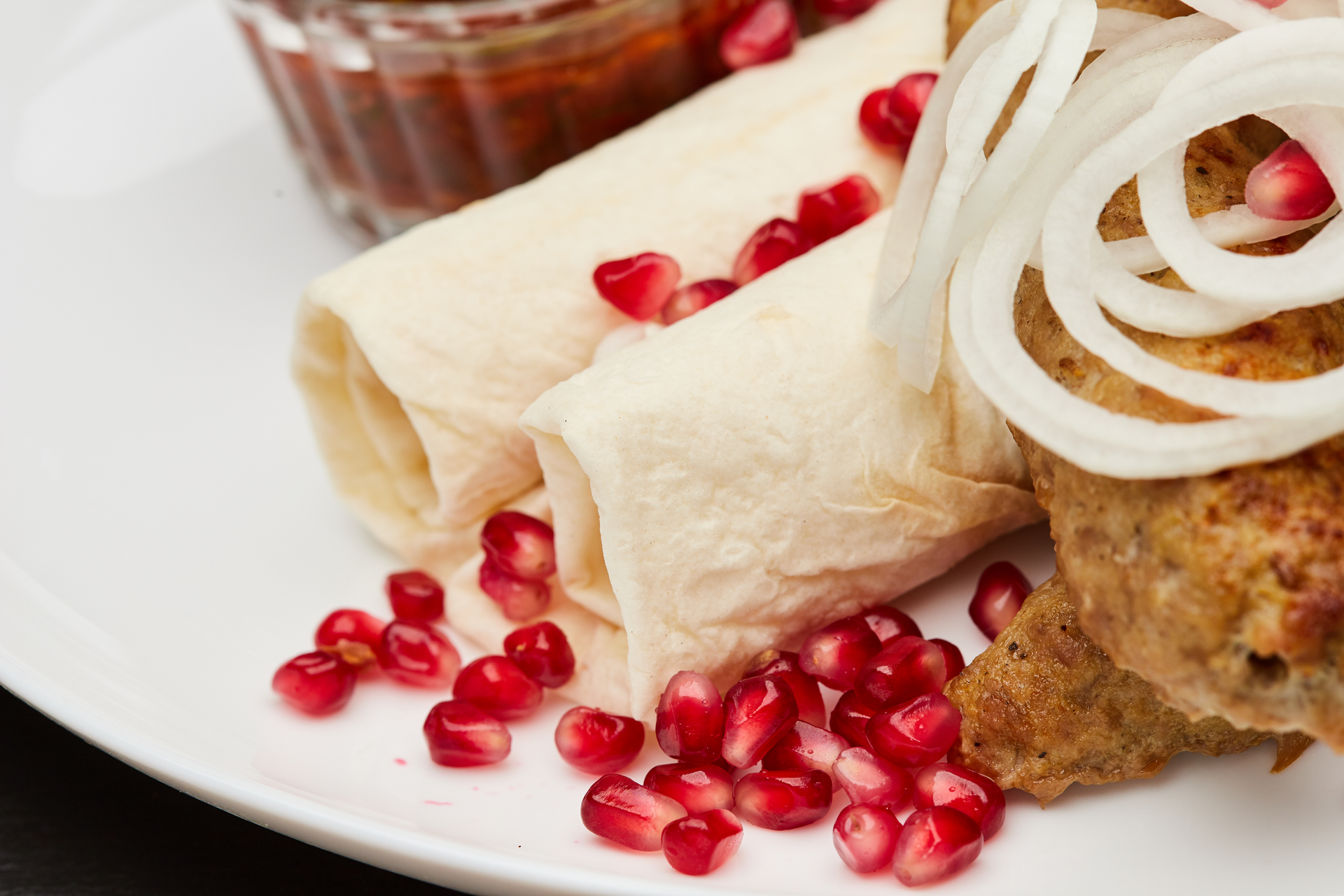 Herbaceous Armenian Lavash Rolls with Pomegranate Arils — Appetizer served and photographed from above