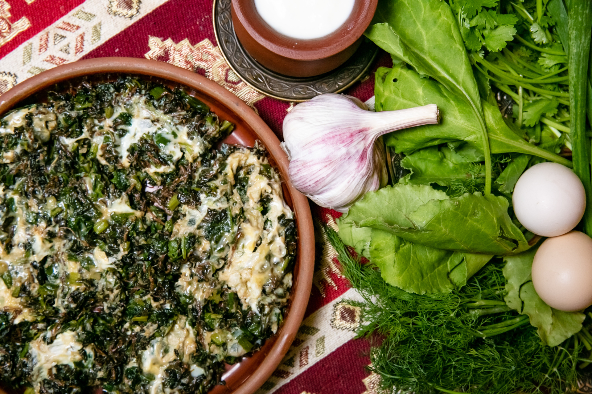 Overhead flat-lay of all ingredients for Herbaceous Greek Spanakorizo with Dill and Feta laid out on a kitchen surface.