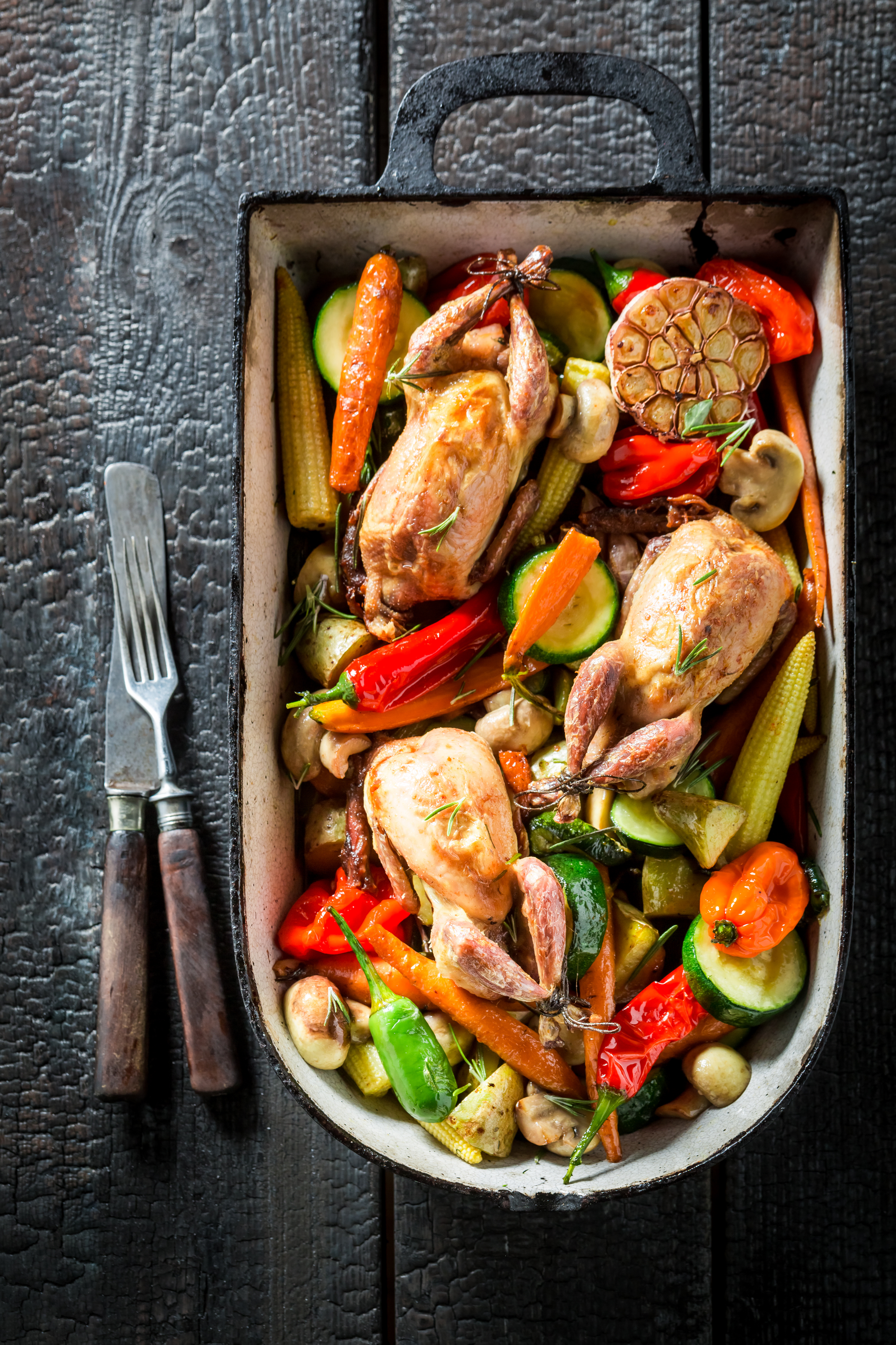 Overhead flat-lay of all ingredients for Honey Garlic Chicken with Roasted Vegetables laid out on a kitchen surface.