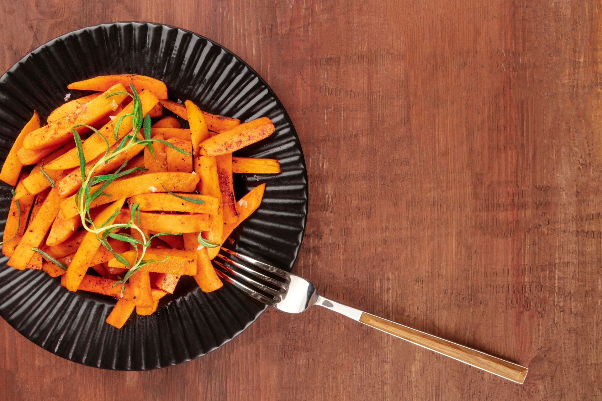 Overhead flat-lay of all ingredients for Honey-Ginger Glazed Korean Sweet Potatoes with Toasted Sesame Seeds laid out on a kitchen surface.