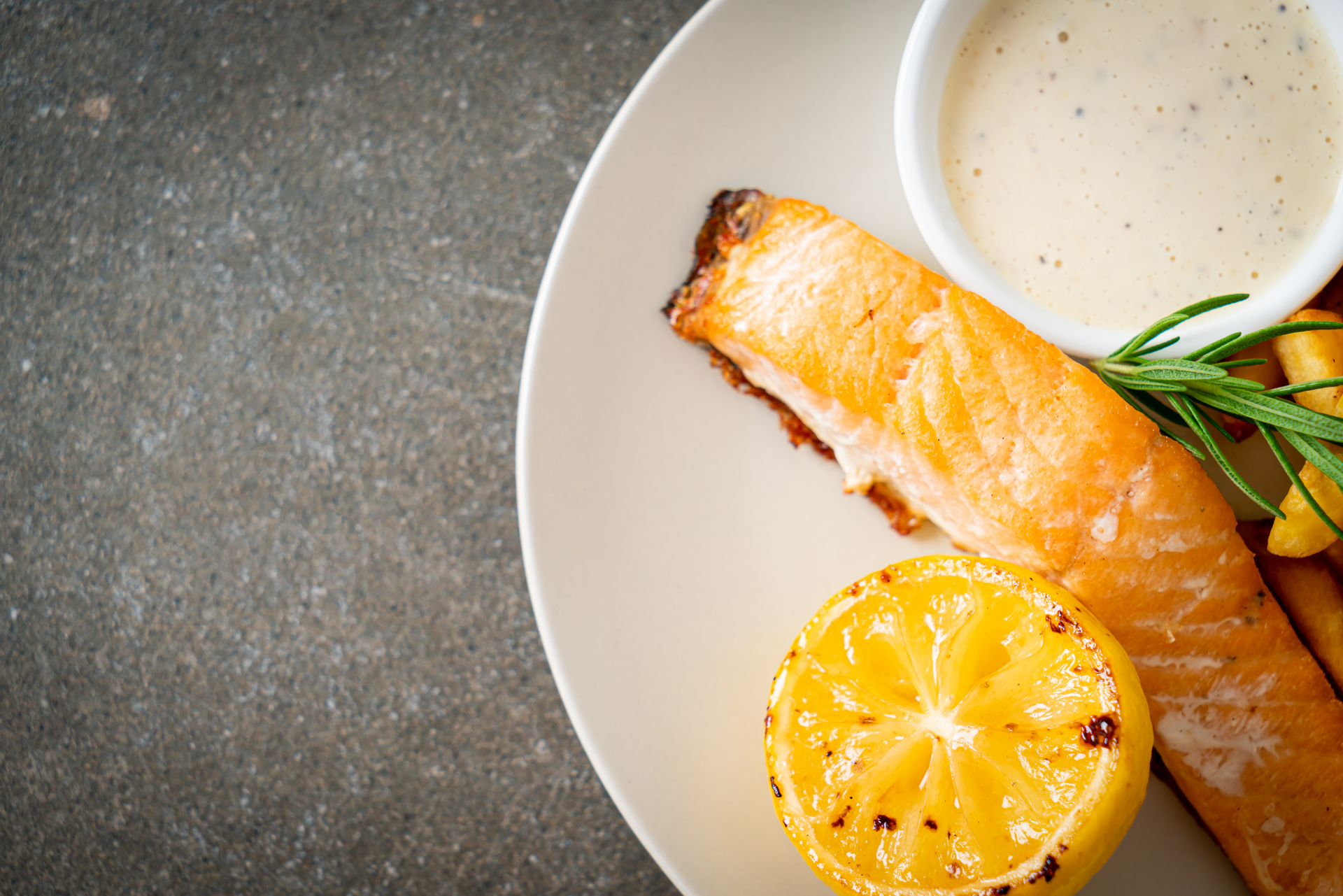 Overhead flat-lay of all ingredients for Honey Mustard Glazed Canadian Salmon with Maple Drizzle laid out on a kitchen surface.