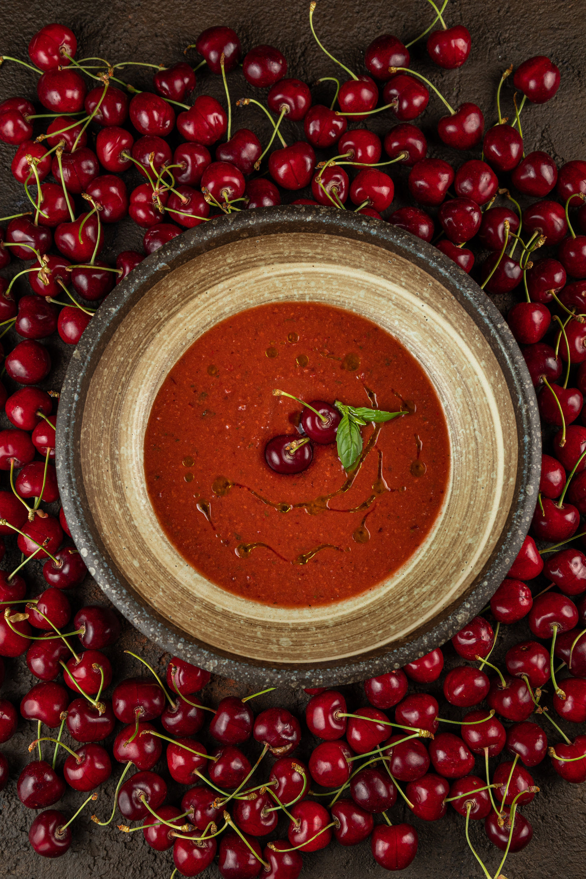 Overhead flat-lay of all ingredients for Hungarian Cherry Soup with Vanilla Cream laid out on a kitchen surface.