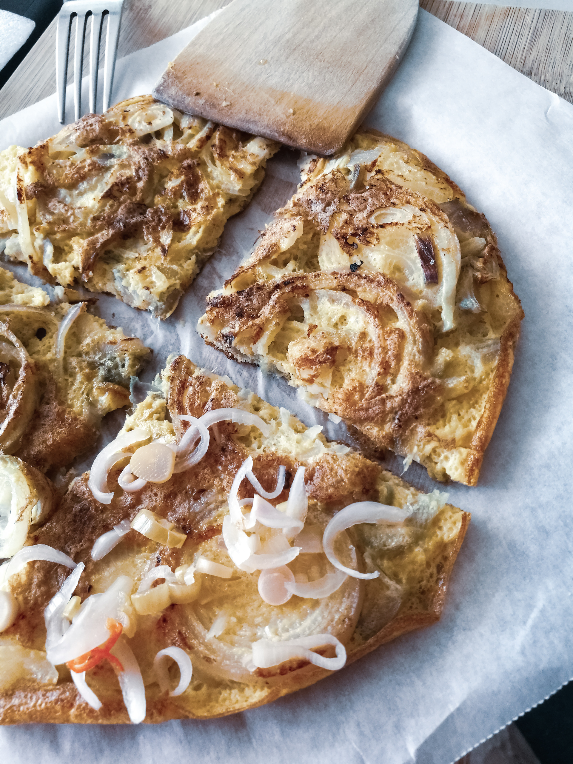 Overhead flat-lay of all ingredients for Hungarian Langos with Garlic Sour Cream and Cheese laid out on a kitchen surface.