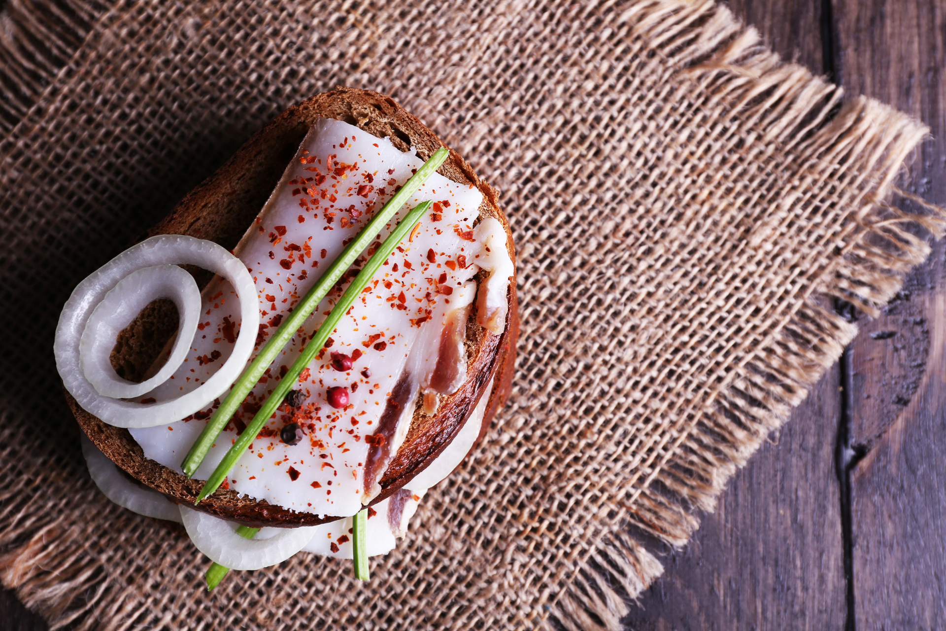 Overhead flat-lay of all ingredients for Icelandic Herb-Infused Langoustine Sandwich with Rye Bread laid out on a kitchen surface.
